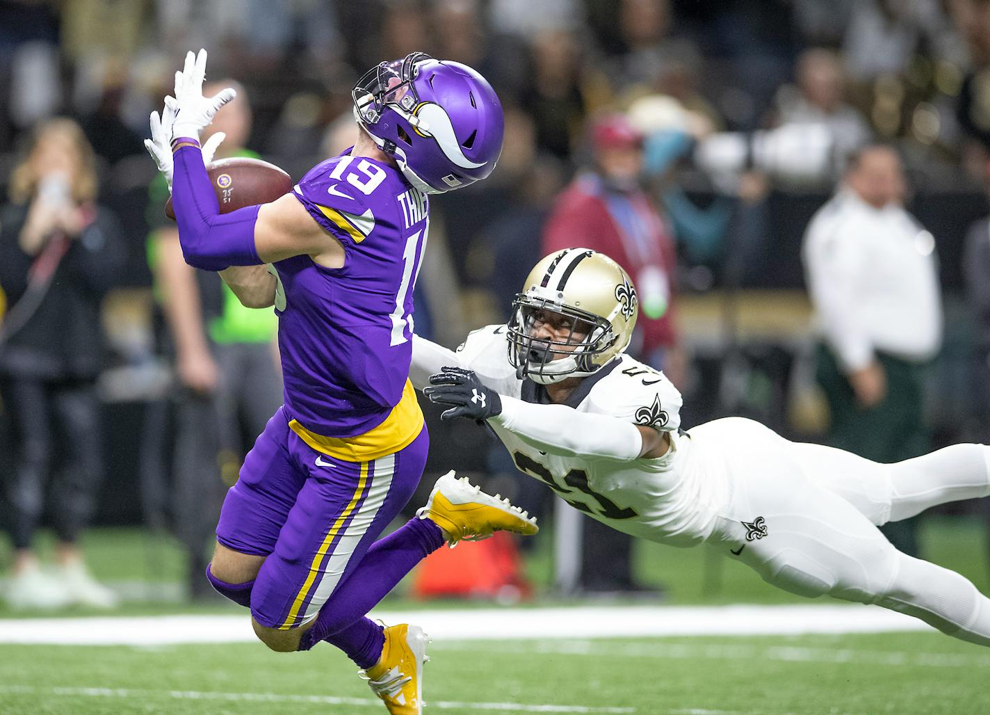 Vikings wide receiver Adam Thielen made a catch over New Orleans defensive back Patrick Robinson in overtime, setting up the game-winning score three plays later.