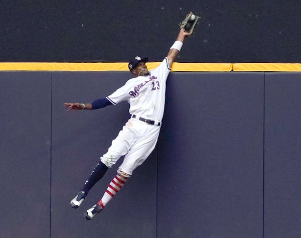 Milwaukee Brewers' Keon Broxton makes a leaping catch at the wall on a ball hit by Minnesota Twins' Brian Dozier during the ninth inning of a baseball