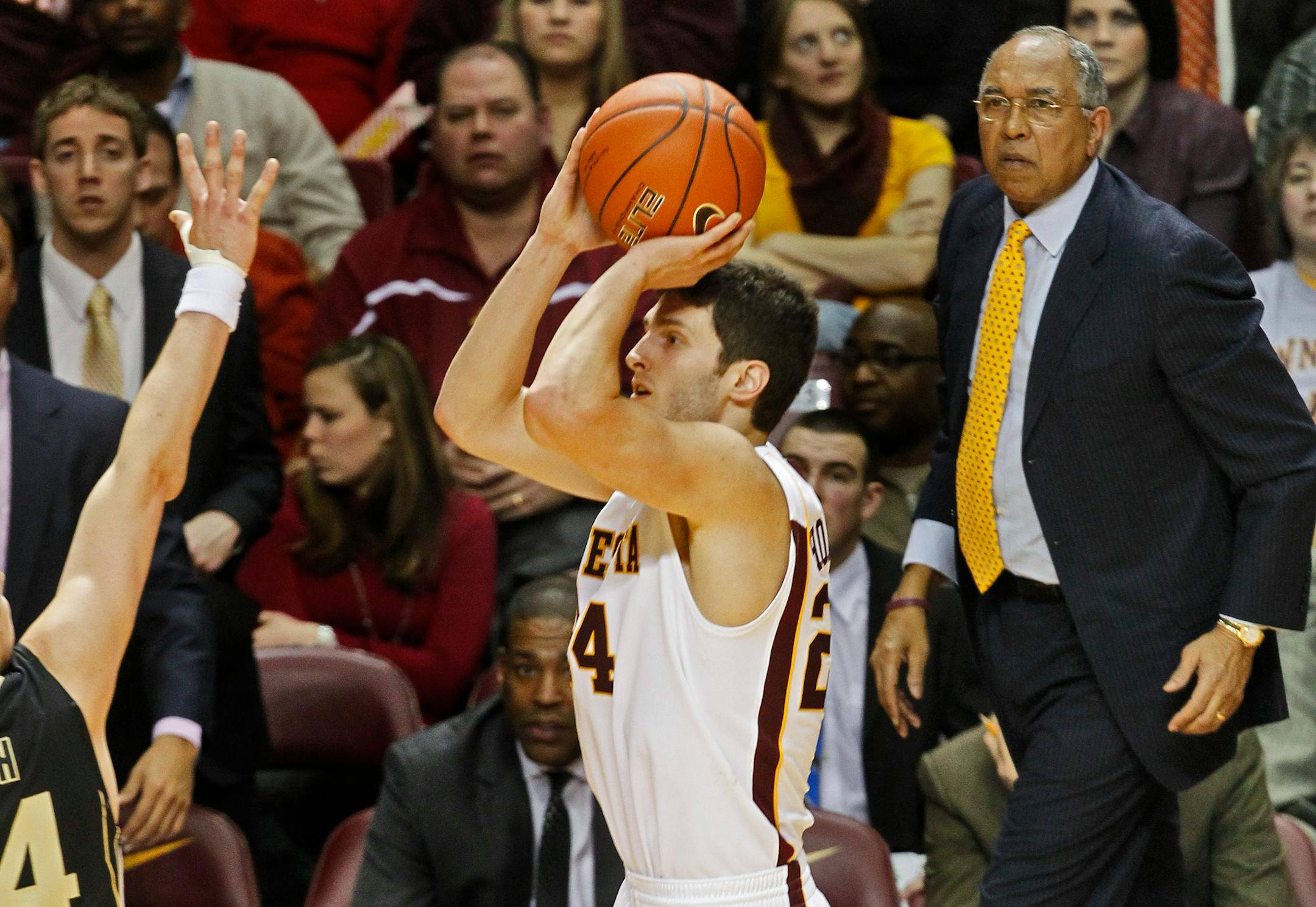 Gophers head coach Tubby Smith, right watched as Blake Hoffarber hit a three point shot in second half play to lead the Gophers with 26 points.