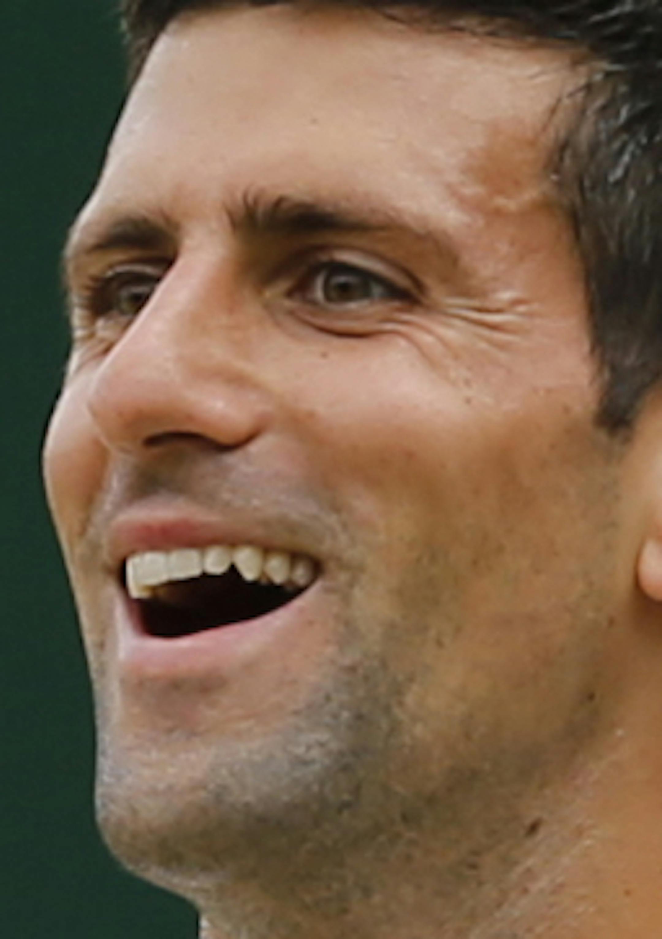 Novak Djokovic of Serbia laughs during a training session at the All England Lawn Tennis Championships in Wimbledon, London, Saturday, July 5, 2014. (AP Photo/Ben Curtis)
