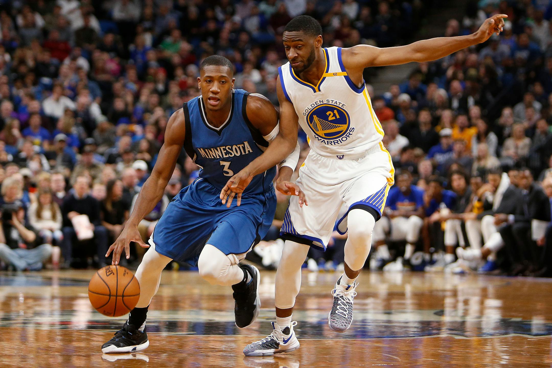 Timberwolves guard Kris Dunn dribbled against Warriors guard Ian Clark in the first half Sunday.