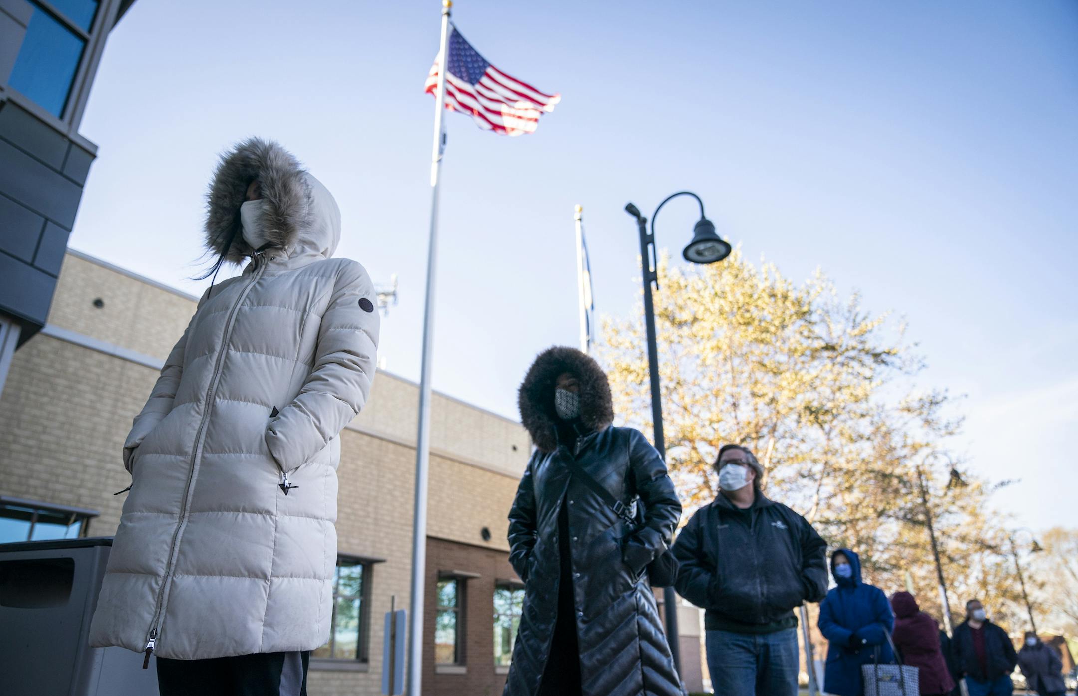 The line of early voters outside the building at the City of Richfield Municipal Center, including first time voter Octavia Rozycki, 18, far left, who drove from college in Mankato to vote, and drove back immediately afterwards. ] LEILA NAVIDI • leila.navidi@startribune.com BACKGROUND INFORMATION: Early voting at the City of Richfield Municipal Center on Tuesday, October 27, 2020. The Richfield DMV closed to focus on in-person absentee ballot voting since they have been too inundated with voters