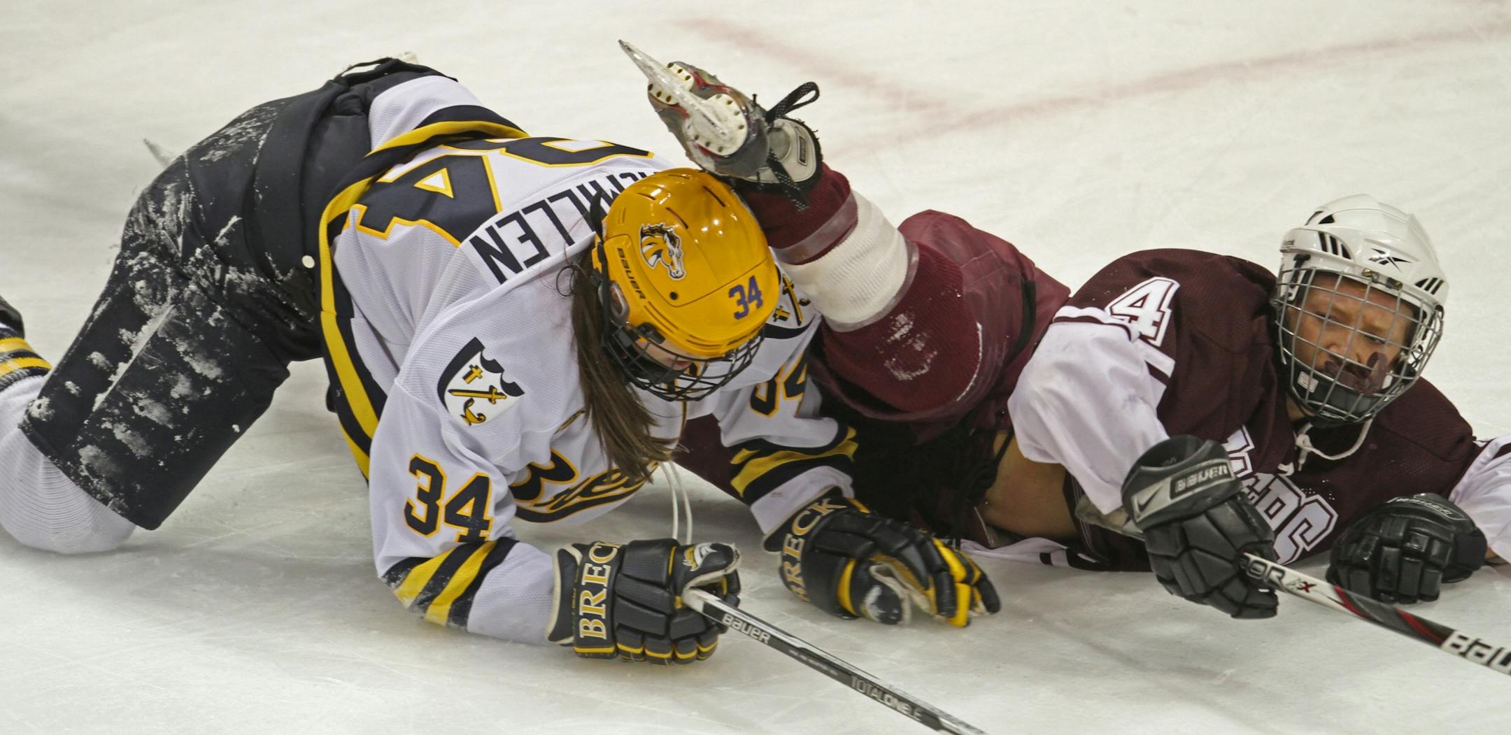 Girls State Hockey Tournament, Class A Championship, Breck vs. South St. Paul. 2/25/12. (left to right) Brecks's Milica McMillen and South St. Paul's Abbie Wisneski crashed to the ice while battling for the puck.