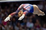 Suni Lee competes on uneven bars during the U.S. Gymnastics Olympic Trials at Target Center on Friday.