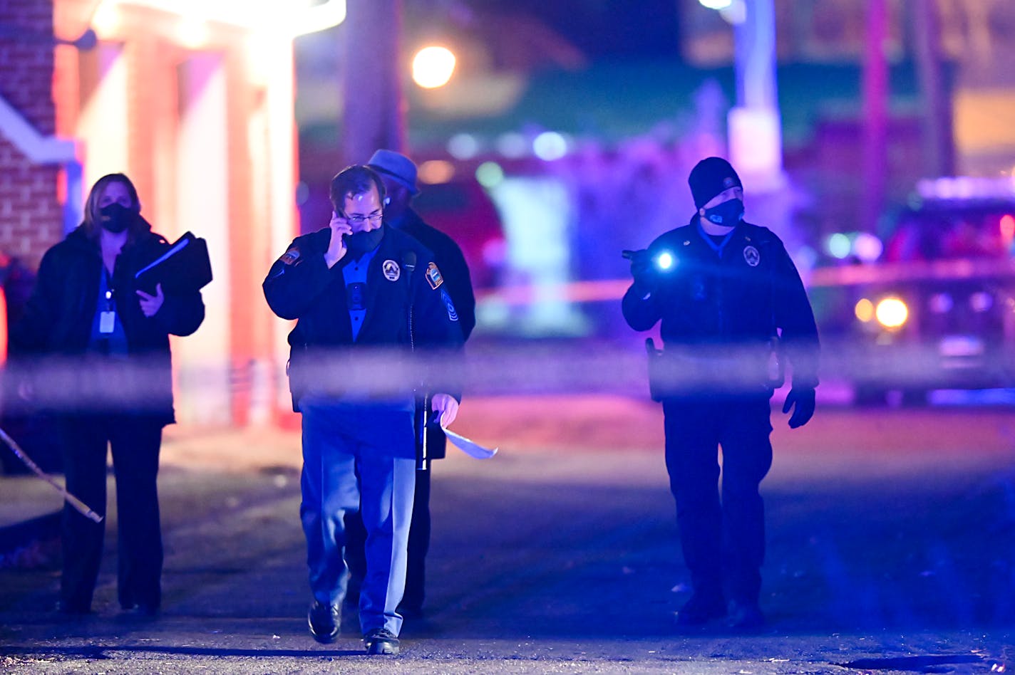 St. Paul police officers and Bureau of Criminal Apprehension (BCA) investigators walked near the scene of an earlier shooting in which St. Paul police shot a person near Rice Street and Magnolia on Saturday night.