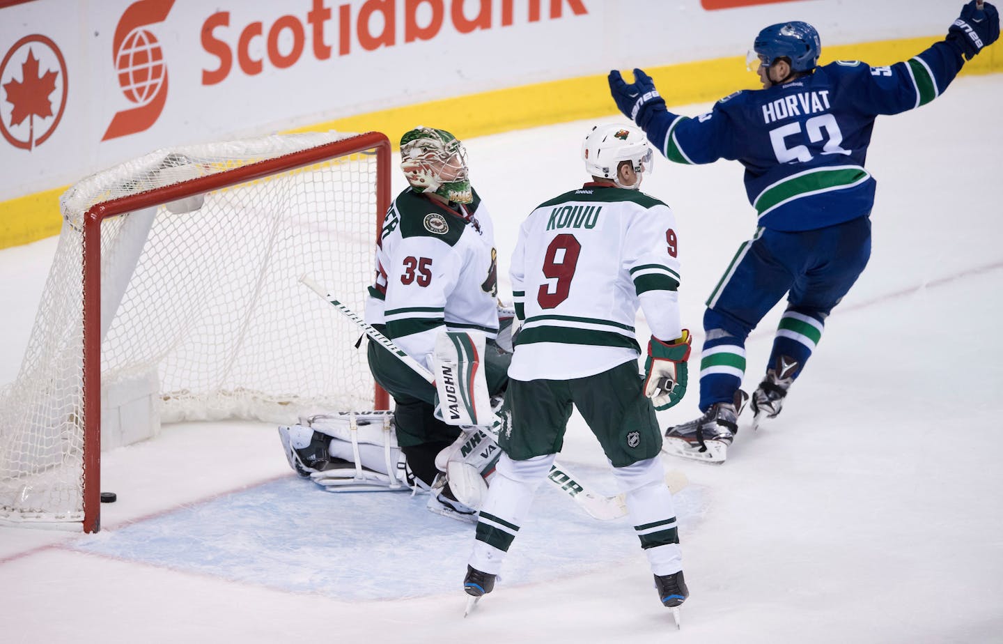 Vancouver Canucks' Bo Horvat, right, celebrates a goal by Sven Baertschi as Minnesota Wild goalie Darcy Kuemper, left, and Wild's Mikko Koivu, of Finland, watch during the third period of an NHL hockey game Tuesday, Nov. 29, 2016, in Vancouver, British Columbia. (Darryl Dyck/The Canadian Press via AP)