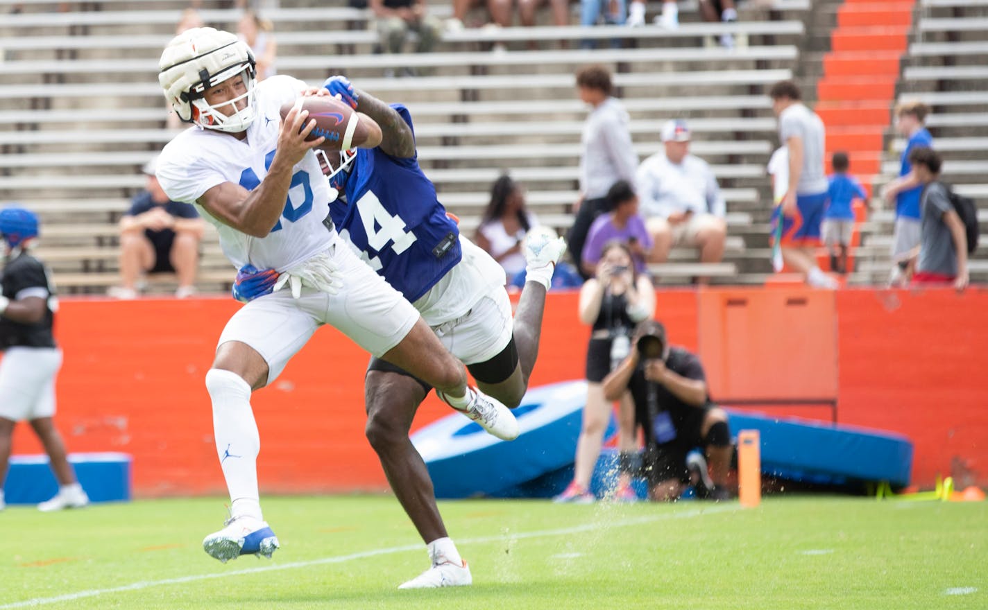 Florida wide receiver Thai Chiaokhiao-Bowman (16) reaches for a pass as safety Jordan Castell (14) defends during NCAA college football practice at Ben Hill Griffin Stadium in Gainesville, Fla., Saturday, Aug. 5, 2023. (Willie J. Allen Jr./Orlando Sentinel via AP)