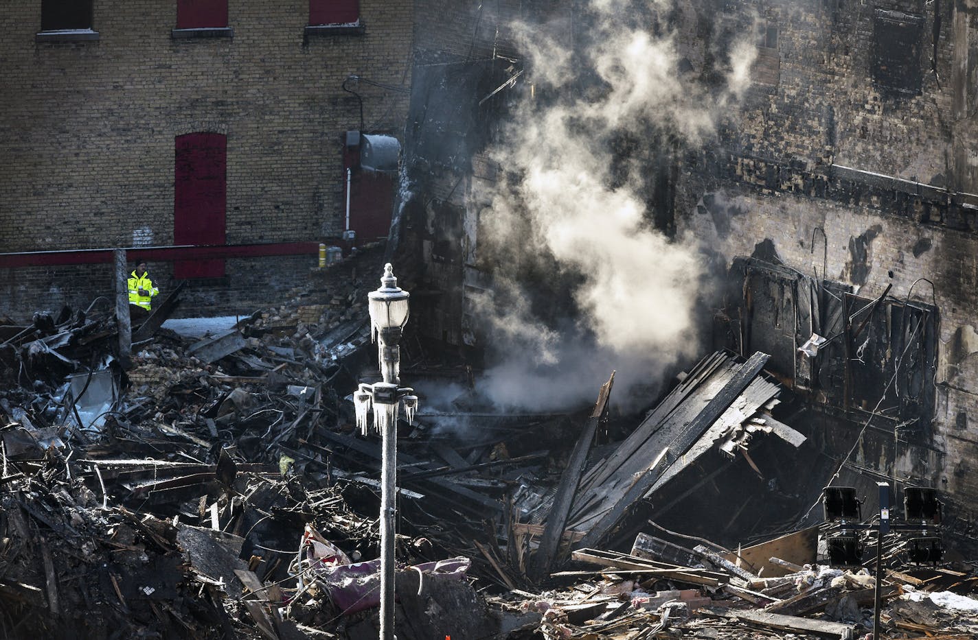 Smoke continues to rise from the rubble at the former location of the Press Bar following a fire, Tuesday, Feb. 18, 2020, in St. Cloud, Minn. The fire was reported at 2:41 a.m. Monday, and firefighters continued to fight the fire for several hours. (Dave Schwarz/St. Cloud Times via AP)