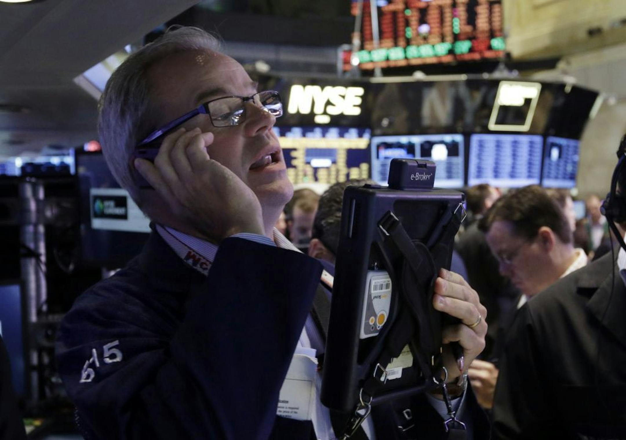 Trader David O'Day works on the floor of the New York Stock Exchange Friday, July 12, 2013. The U.S. stock market rally that led to record highs on Thursday has stalled. Major indexes were little changed in morning trading Friday.
