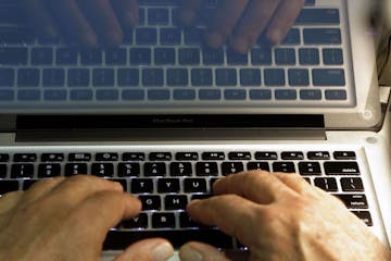 FILE - In this Feb. 27, 2013 photo illustration, hands type on a computer keyboard in Los Angeles. Frustration over passwords is as common across the 