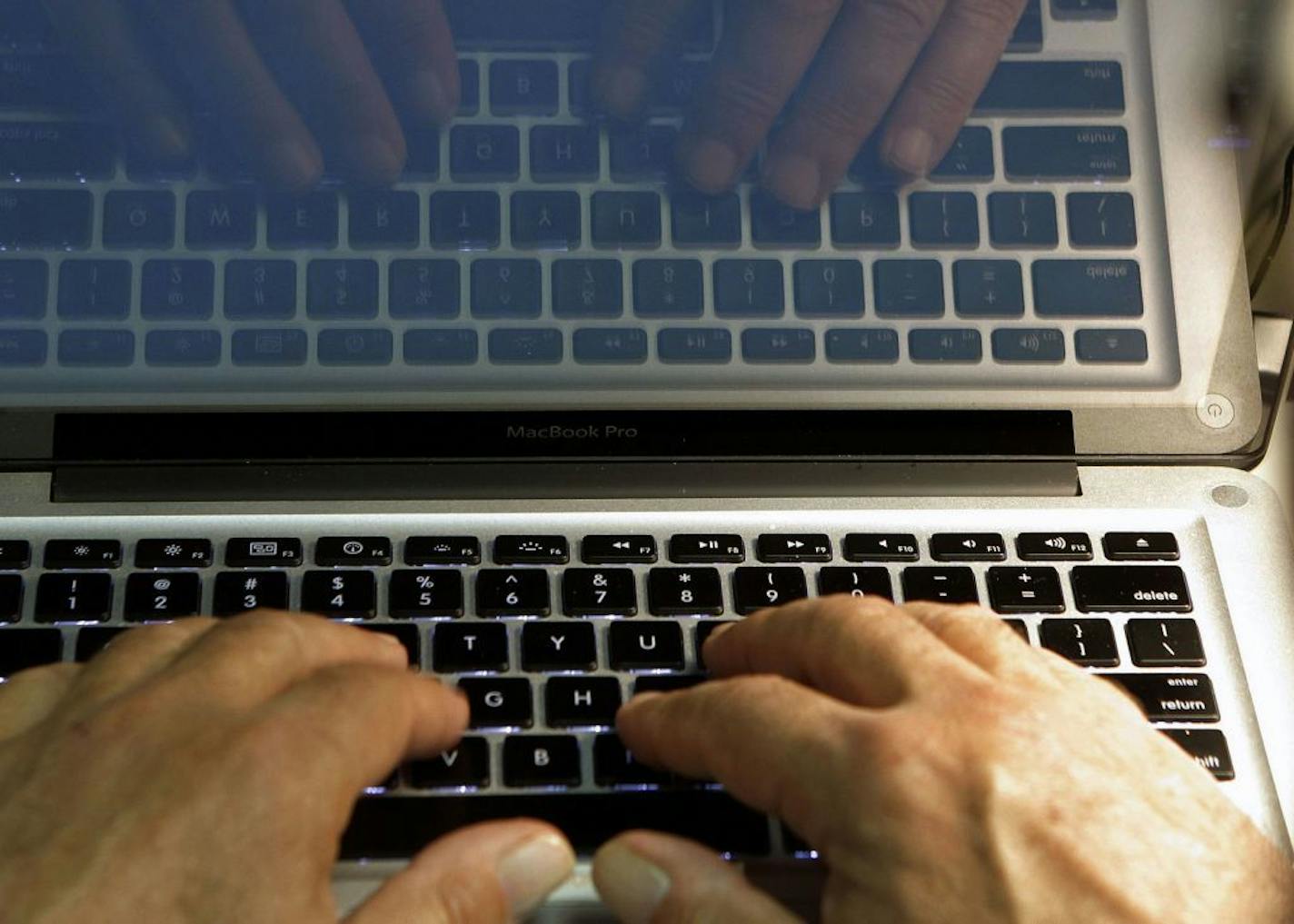 FILE - In this Feb. 27, 2013 photo illustration, hands type on a computer keyboard in Los Angeles. Frustration over passwords is as common across the age brackets. Bill Lidinsky, director of security and forensics at the School of Applied Technology at the Illinois Institute of Technology, recommends using a �simple mental algorithm,� including those that use a space, if a site allows that.