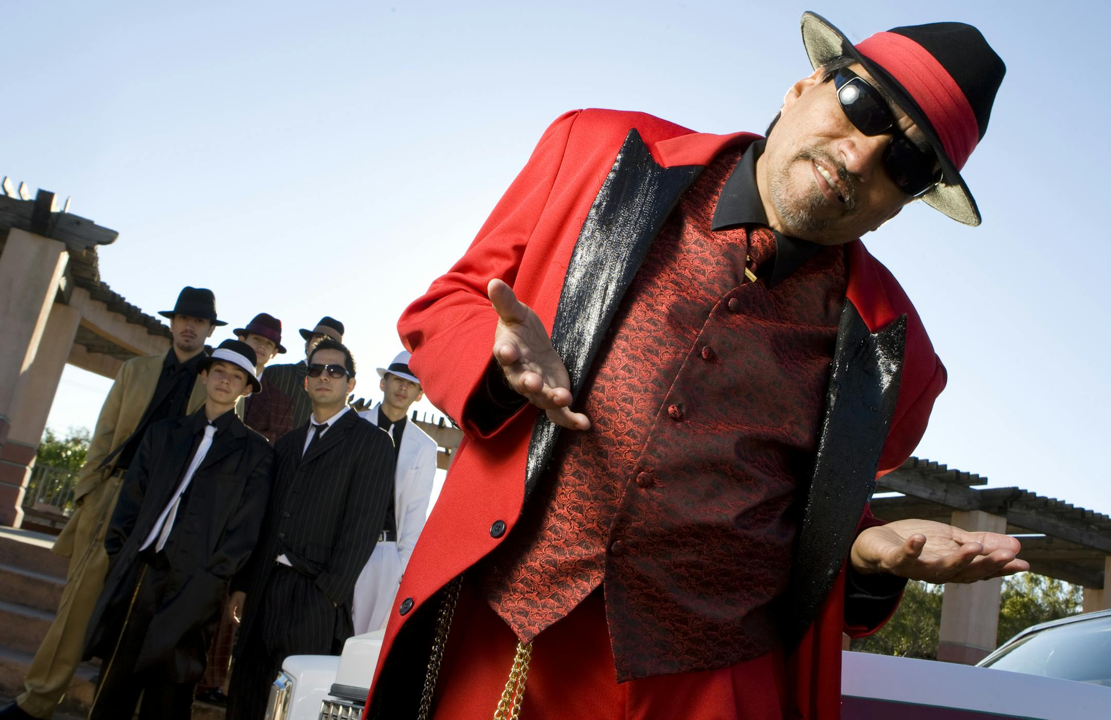 FILE - In this Nov. 15, 2008 file photo, Houston's Pancho Claus, Richard Reyes, poses with his helpers at Guadalupe Plaza on Houston's east side. (AP Photo/Houston Chronicle, Nick de la Torre, File) MANDATORY CREDIT