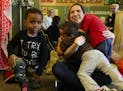 It's hugs for Alyssa Monas at the end of the music therapy session at Childhaven. These sessions are among the kids' favorite. (Alan Berner/Seattle Ti