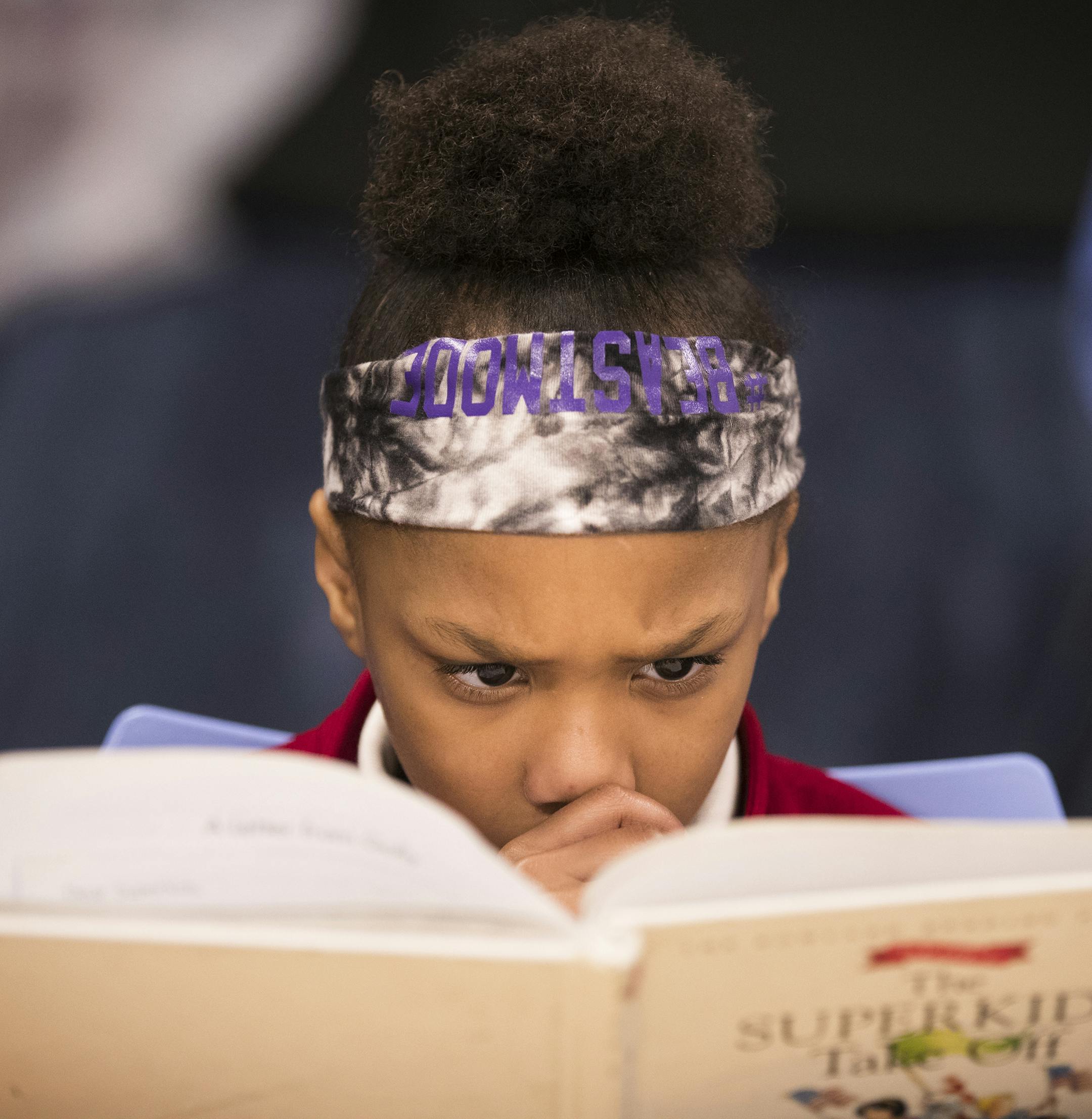 Second-grader Alexandria Hill, above, did some serious reading at Ascension Catholic School in north Minneapolis.