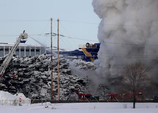 Firefighters on the scene of a fire that had been burning for more than 24 hours at the Northern Metals Recycling plant in Becker, Minn.