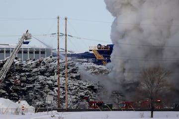 Firefighters on the scene of a fire that had been burning for more than 24 hours at the Northern Metals Recycling plant in Becker, Minn.