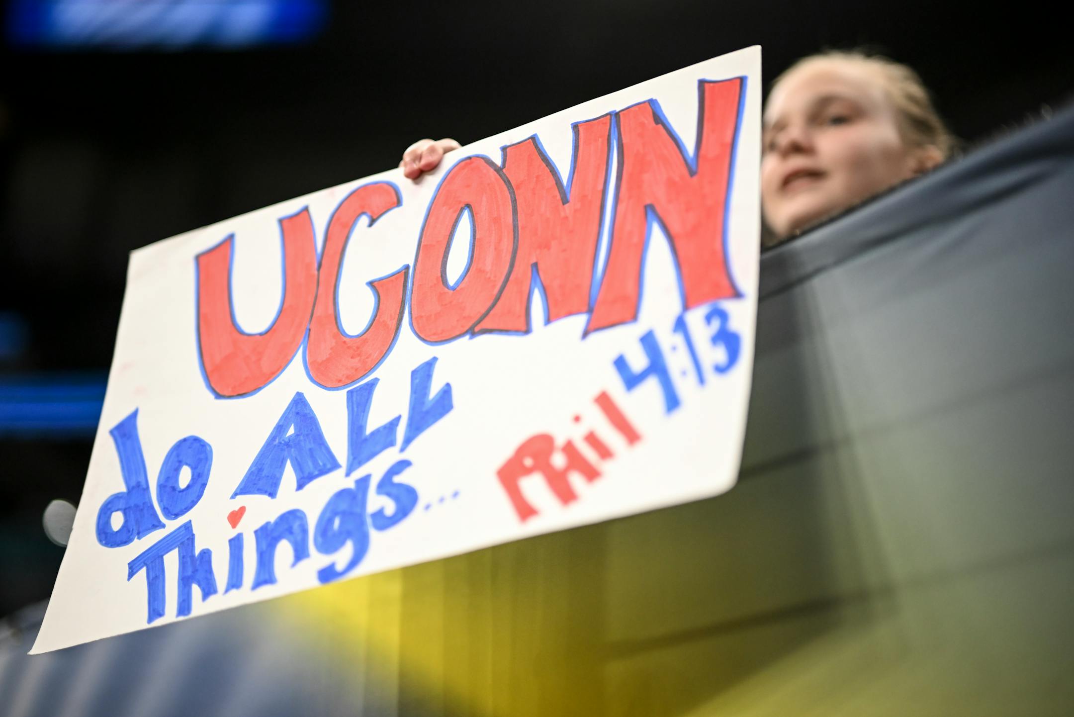 Tate Addler, 12, of Minnetonka, holds up a UConn sign during a Final Four open practice held Saturday, April 2, 2022 at Target Center in Minneapolis, Minn.