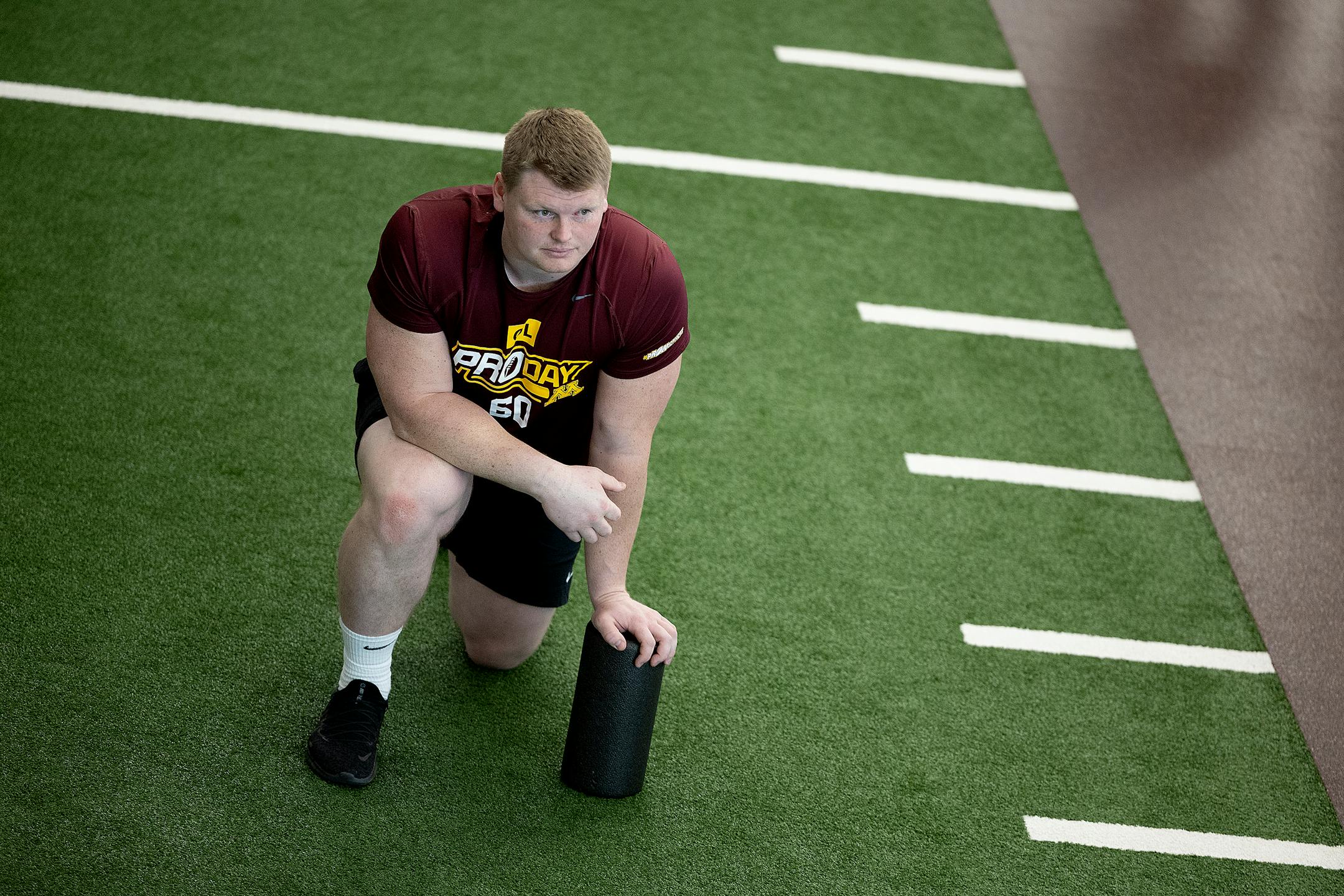 Minnesota's Center John Michael Schmitz watches other players jump the vertical jump during the Minnesota Pro Day in the indoor football facility at the Athletes Village in Minneapolis.