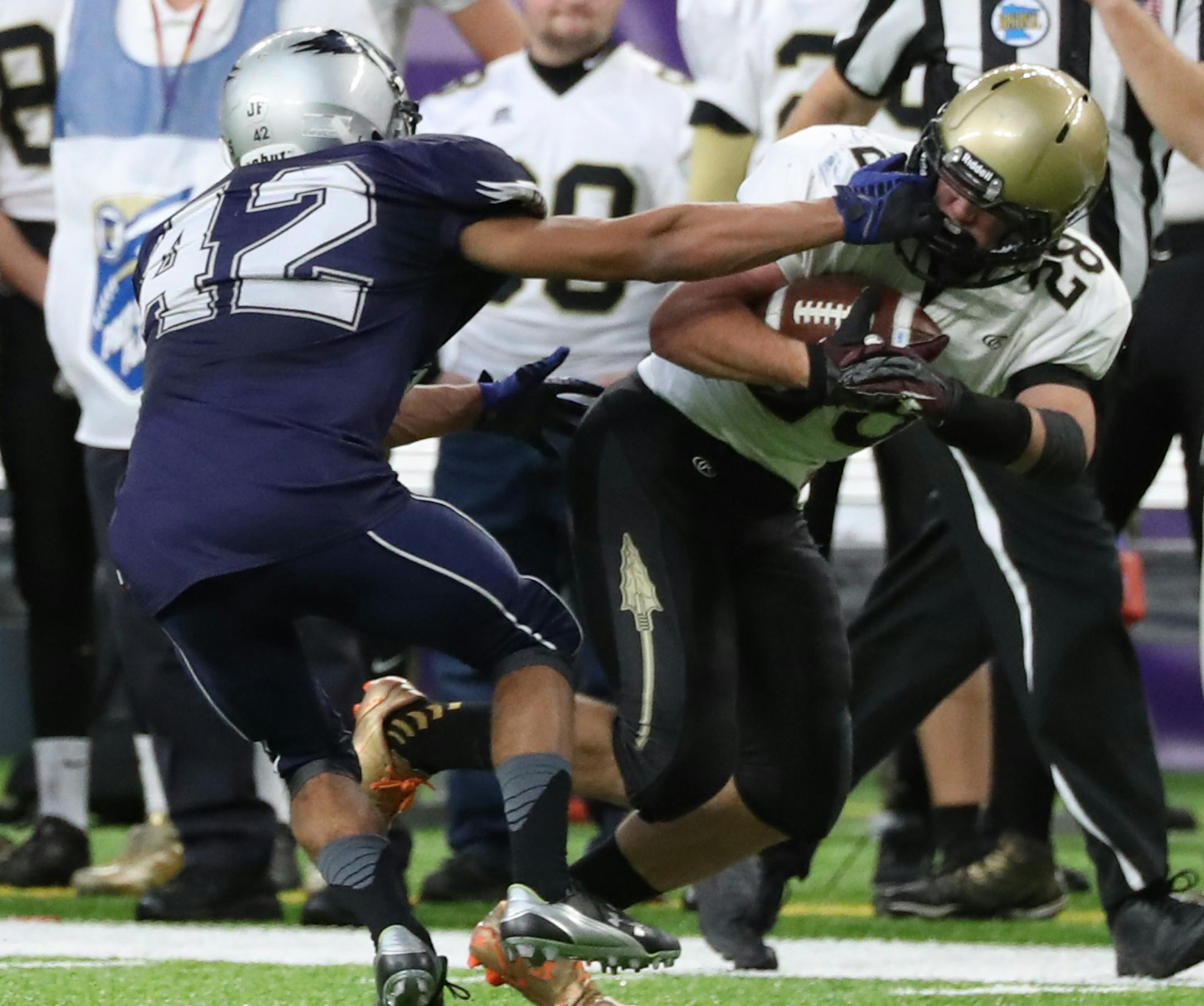 Defensive facemask was the call after this play in the first half when Eden Valley-Watkins' Deshaun Haag tried to tackle Caldeonia's Ben McCabe. ] Shari L. Gross / sgross@startribune.com Caledonia led Eden Valley-Watkins 40-0 at halftime in the 2A football championship at U.S. Bank Stadium in Minneapolis, Minn. on Friday, Nov. 24, 2016.