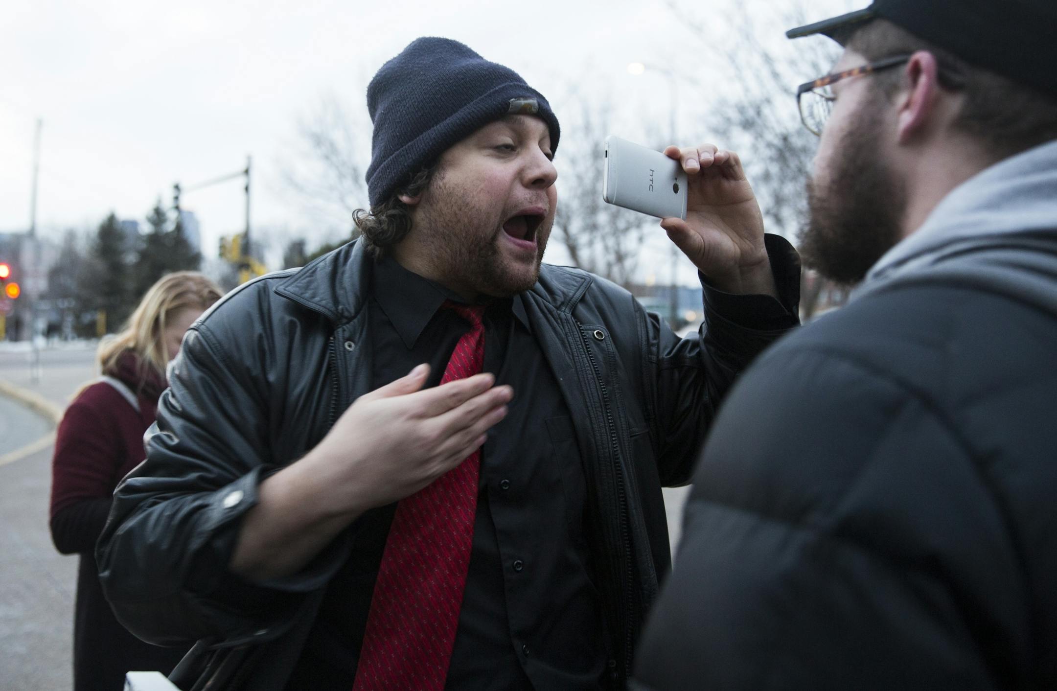Martin Kiley Medved, left, a free speech advocate, interrupts a protest against Milo Yiannopoulos and Christina Hoff Sommers outside the Humphrey Institute of Public Affairs on the campus of the University of Minnesota in Minneapolis on Wednesday, February 17, 2016. The protester on the right, who was part of the protest against Milo Yiannopoulos and was trying to stop Medved from interrupting them, did not want to give his name.