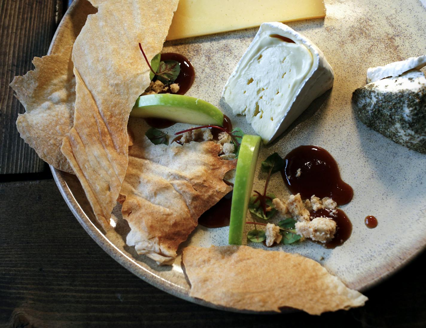 Regional cheeses with crackers, fruits and preserves.