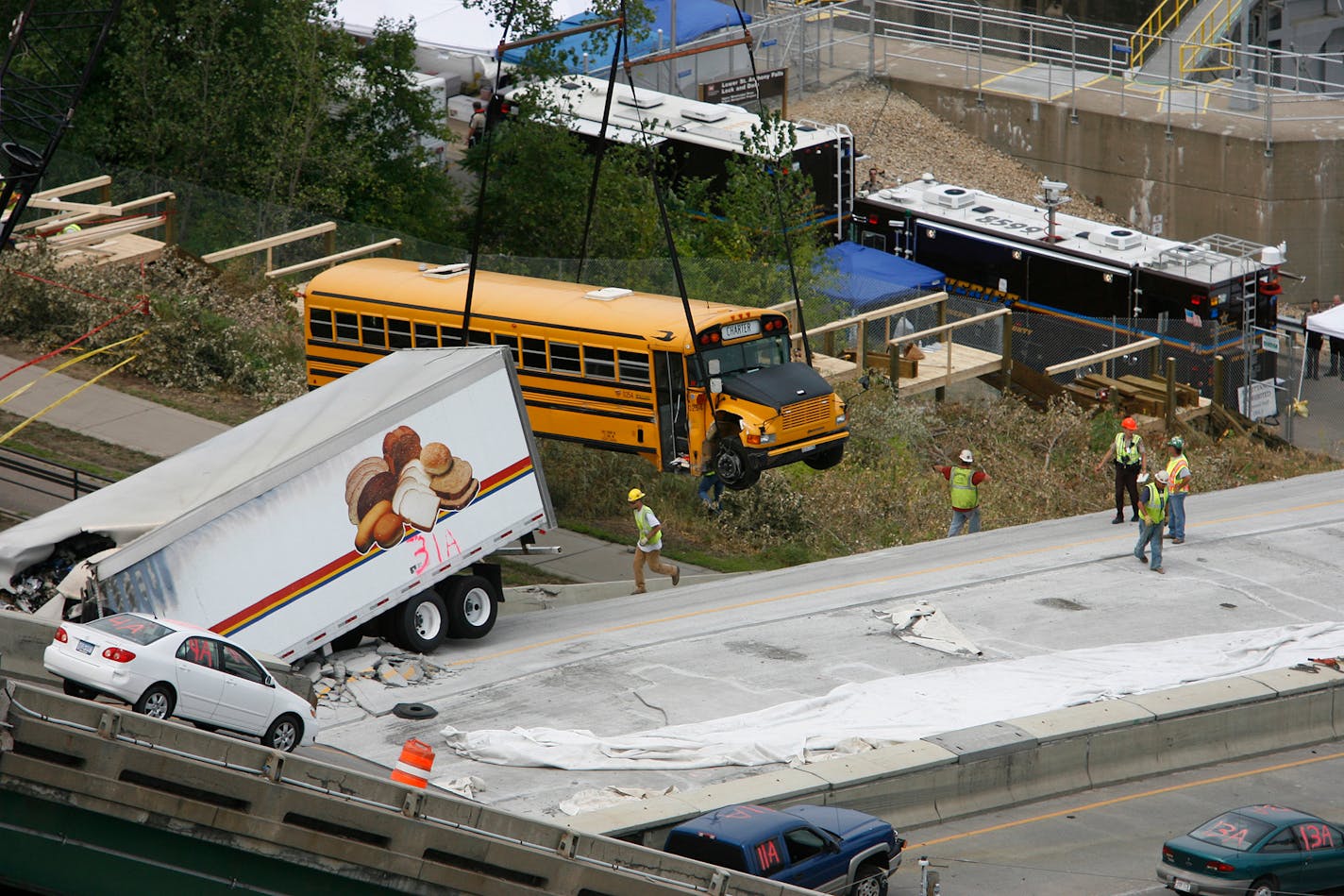 The school bus that was on the I-35W bridge when it collapsed is removed from the south side of bridge in August 2007.