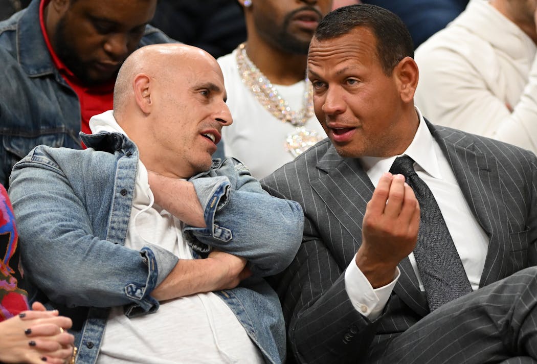 Timberwolves minority owners Marc Lore and Alex Rodriguez talk in the first row during a basketball game between the Minnesota Timberwolves and the Philadelphia 76ers Nov. 22, 2023 at Target Center in Minneapolis.