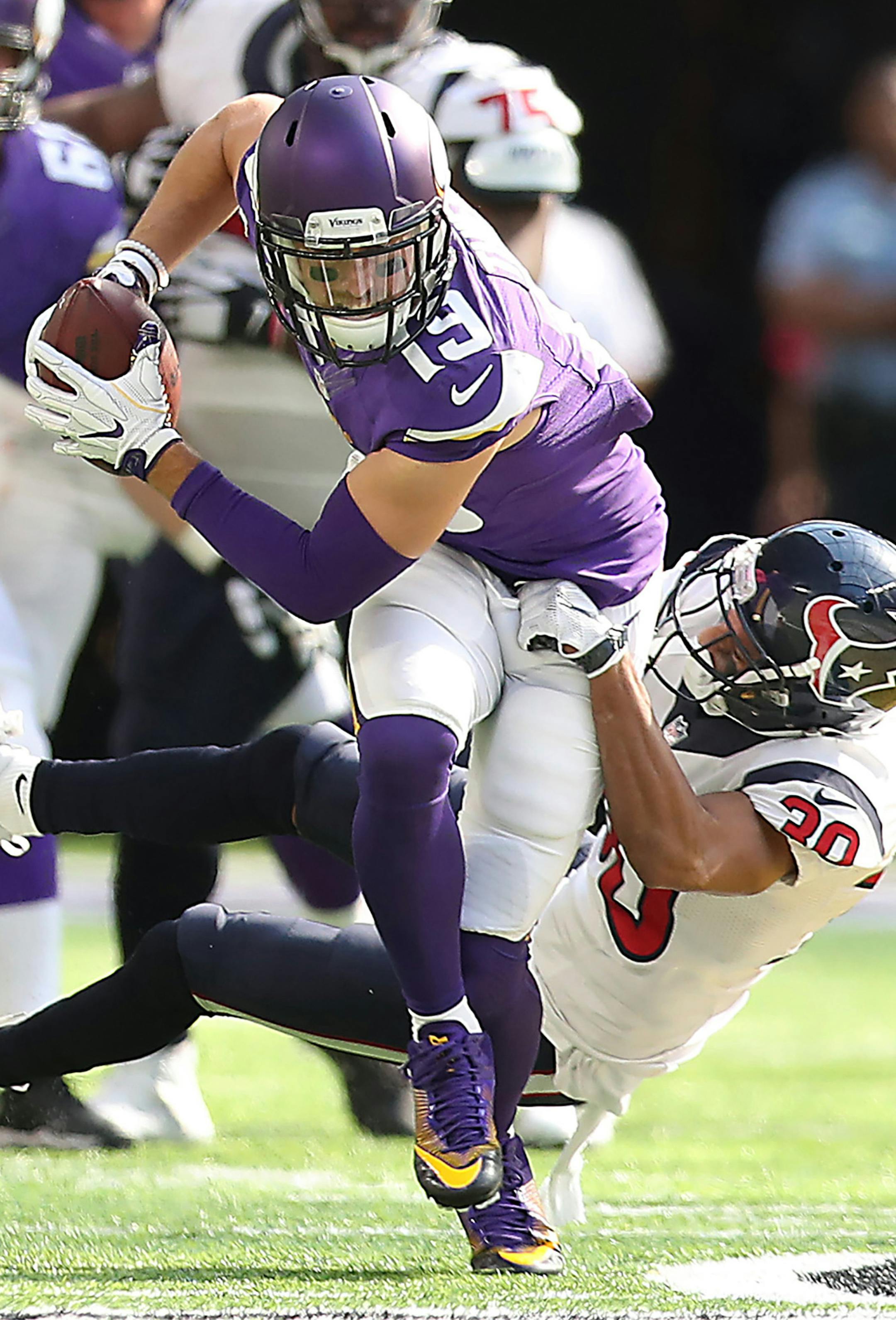 Minnesota Vikings wide receiver Adam Thielen carries the ball despite being held by Houston Texans cornerback Kevin Johnson during the third quarter on Sunday, Oct. 9, 2016 at U.S. Bank Stadium in Minneapolis, Minn. (Elizabeth Flores/Minneapolis Star Tribune/TNS) ORG XMIT: 1191369
