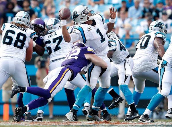 Cam Newton (1) was sacked by Harrison Smith (22) in the fourth quarter.