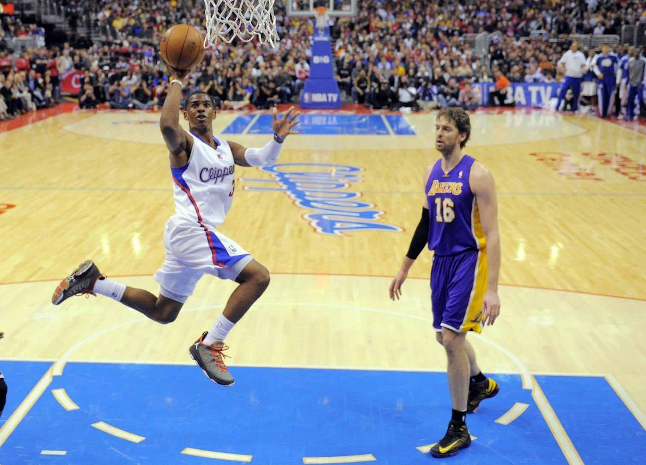 Los Angeles Clippers guard Chris Paul, left, puts up a shot as Los Angeles Lakers forward Pau Gasol, of Spain, looks on during the second half of their NBA basketball game, Friday, Jan. 4, 2013, in Los Angeles. The Clippers won 107-102.