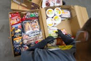 Tyrome Williams, a volunteer warehouse lead, sorteds food at Southern Anoka Community Assistance Food Shelf in Columbia Heights in January. Minnesota 