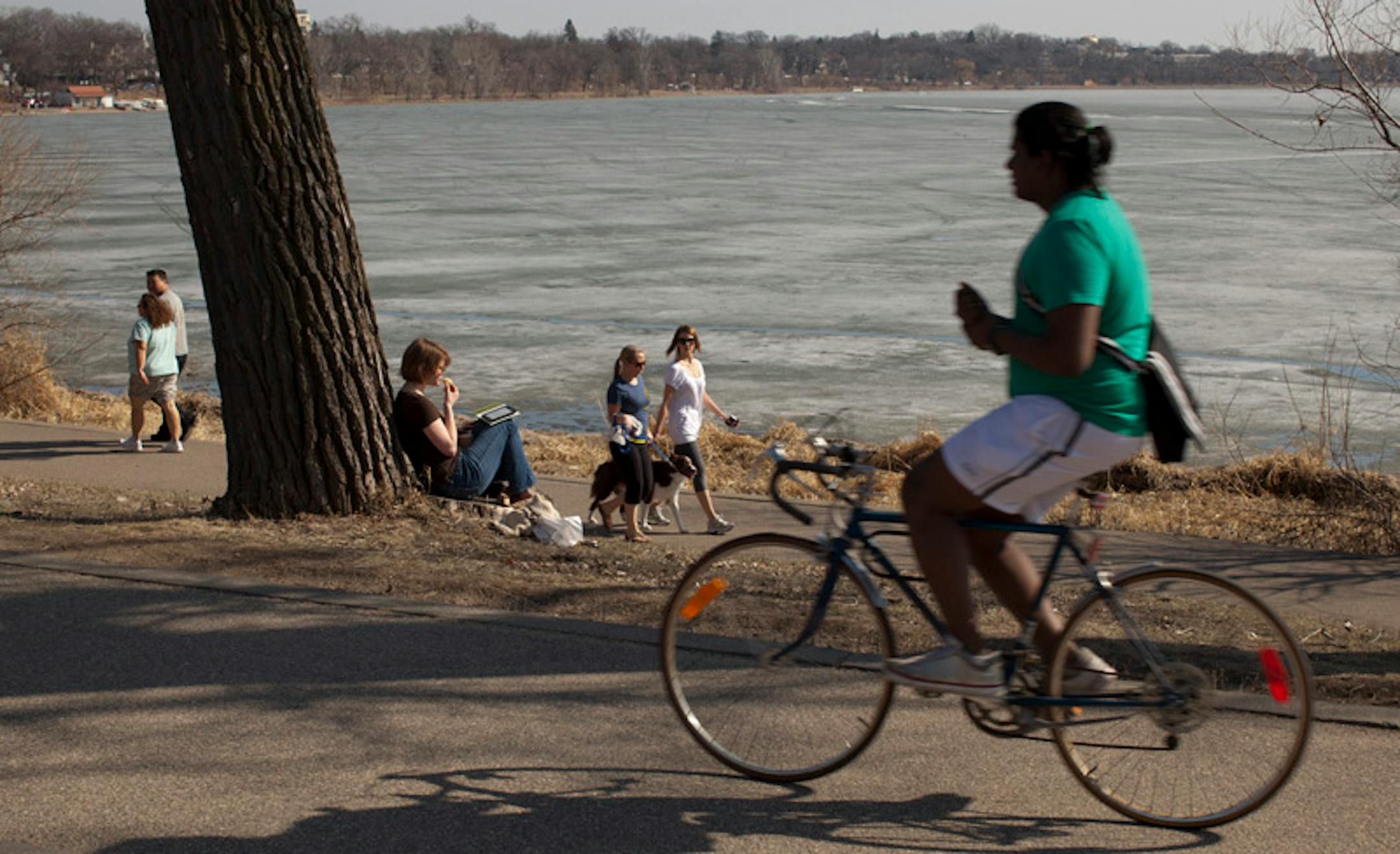 More unseasonably warm weather beckoned people outside on a perfect spring afternoon Wednesday, March 14, 2012 in Minneapolis, Minn.