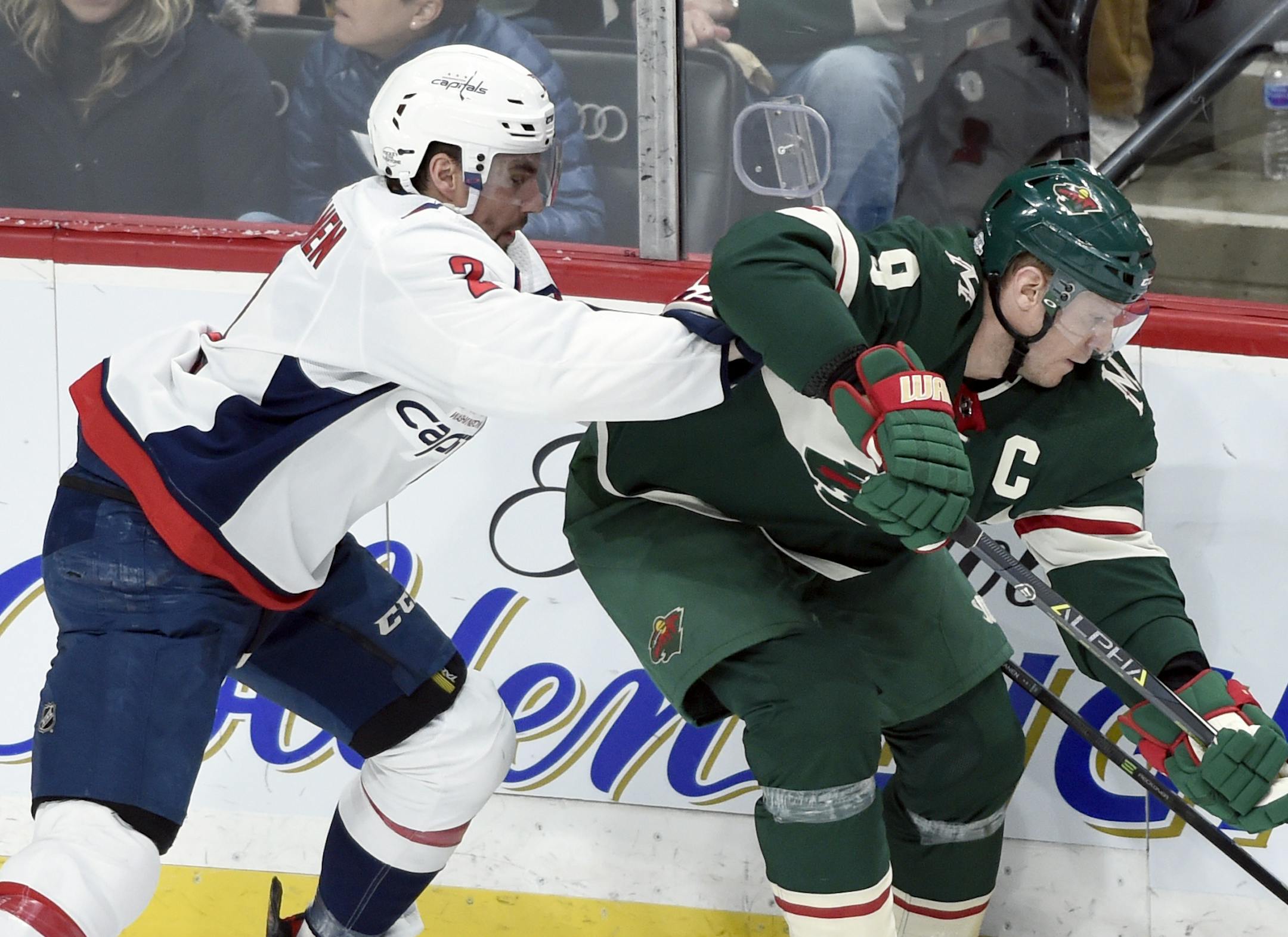 Minnesota Wild's Mikko Koivu (9), of Finland, tries to keep the puck from Washington Capitals' Matt Niskanen (2) during the first period of an NHL hockey game Thursday, Feb. 15, 2018, in St. Paul, Minn. (AP Photo/Hannah Foslien)