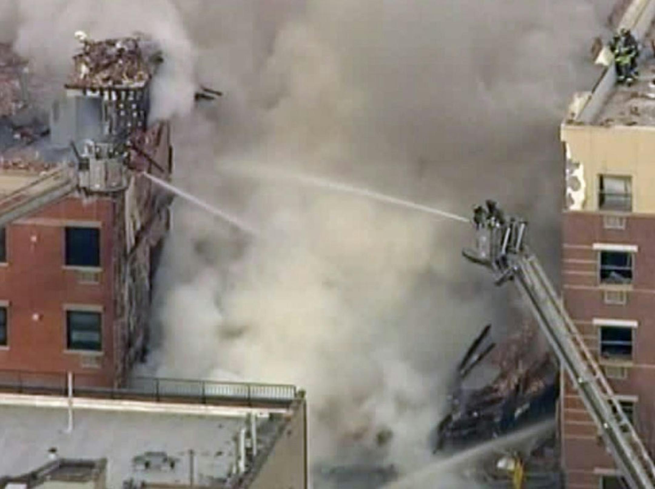 In this image taken from video from WABC, firefighters battle a blaze at the site of a possible explosion and building collapse in the East Harlem neighborhood of New York, Wednesday, March 12, 2014.