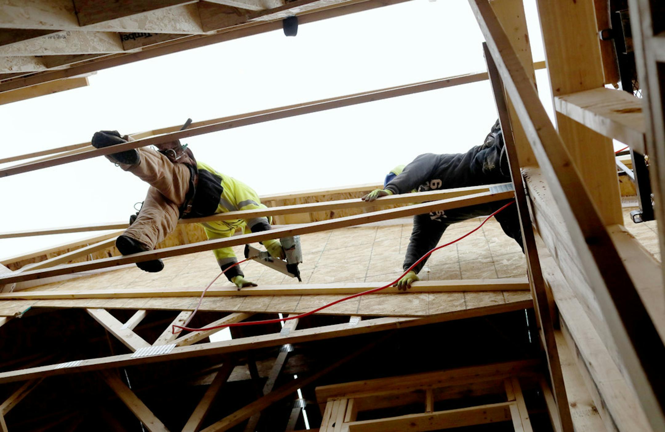 Shade Tree Construction carpenters and brothers Juan Alejos, left, Eddie Alejos work on building a 2,100 square foot, three bedroom, three bath, side by side model townhome Wednesday, Nov. 28, 2018, in Mounds View, MN.] DAVID JOLES &#x2022; david.joles@startribune.com Home building in the Twin Cities is in the midst of a seasonal slowdown, but sales of entry level new houses have been robust. Buildable lots that are affordable to entry level buyers, however, are in short supply.** Juan Alejos ,