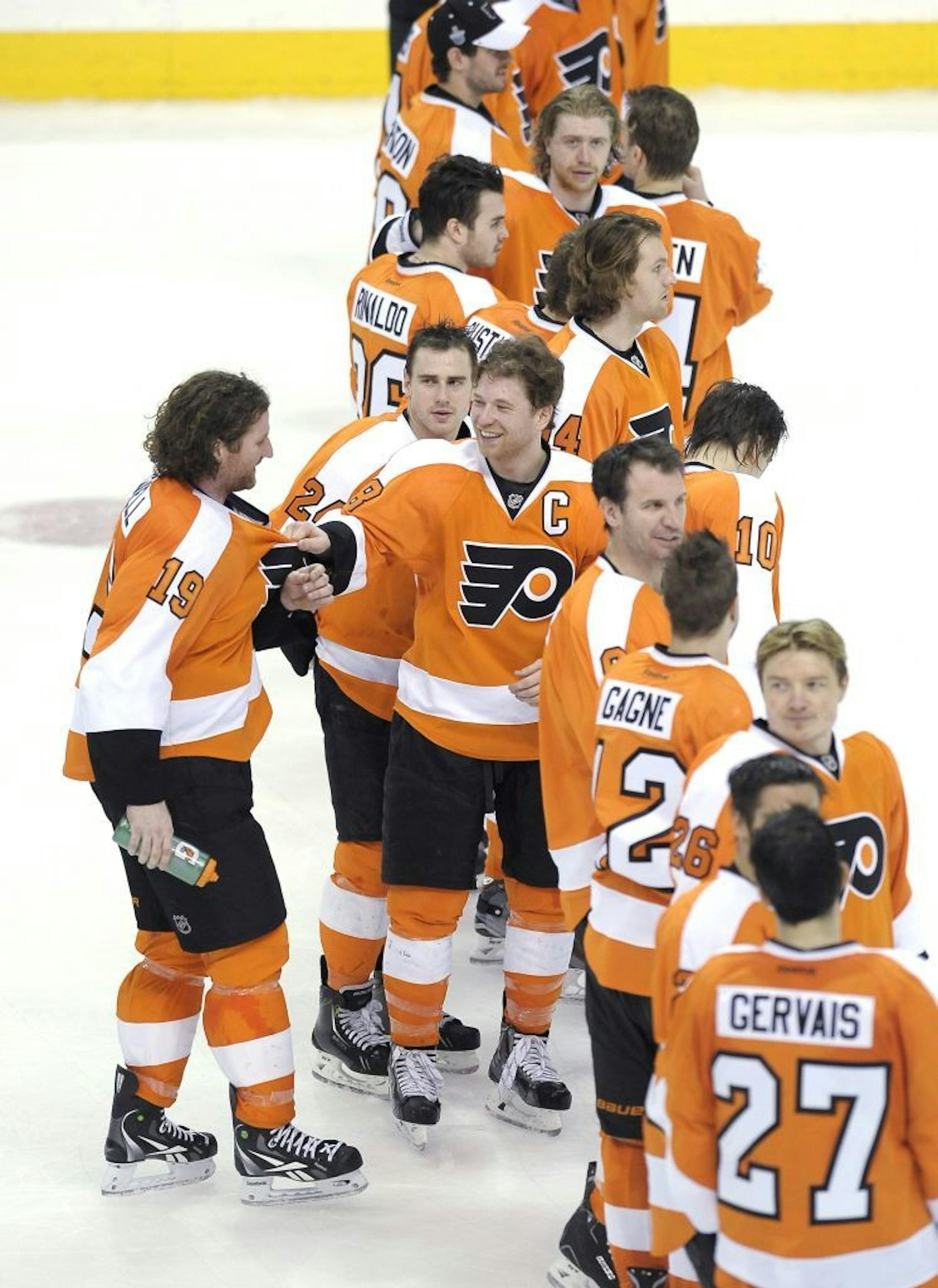 Philadelphia Flyers' Scott Hartnell (19) talks to Claude Giroux (28) in the third period of an NHL hockey game against the Boston Bruins, Saturday, March 30, 2013, in Philadelphia. The Flyers won 3-1.