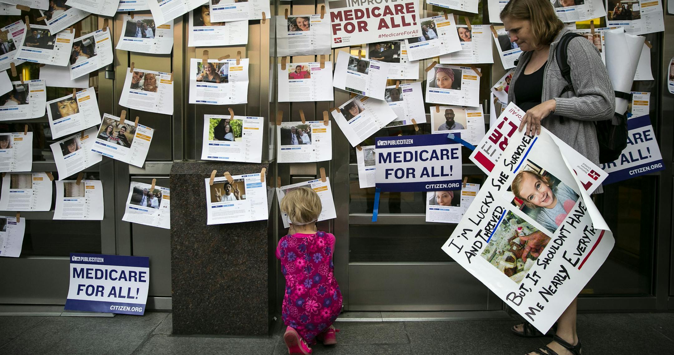 Supporters of “Medicare for All” display photos of people who have relied on crowdfunding to pay for their medical expenses, in Washington, April 29, 2019. The Congressional Budget Office on Wednesday published a much-awaited paper about the possible design of a single-payer, but it did not profile detailed estimates of how much such a system might cost. (Al Drago/The New York Times)