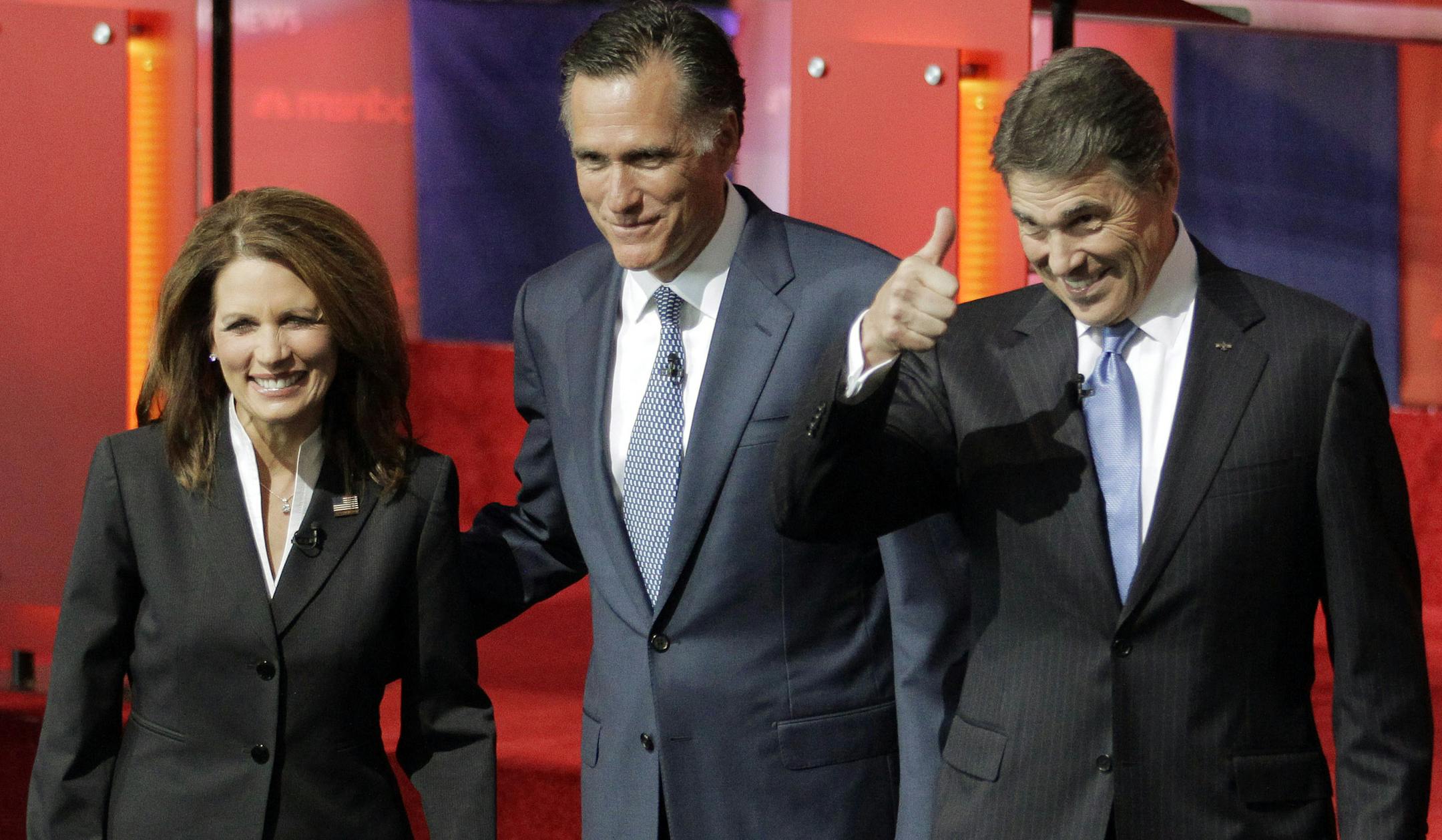 Michele Bachmann had few chances to speak early in Wednesday's debate, as Mitt Romney, center, and Rick Perry dominated the attention.