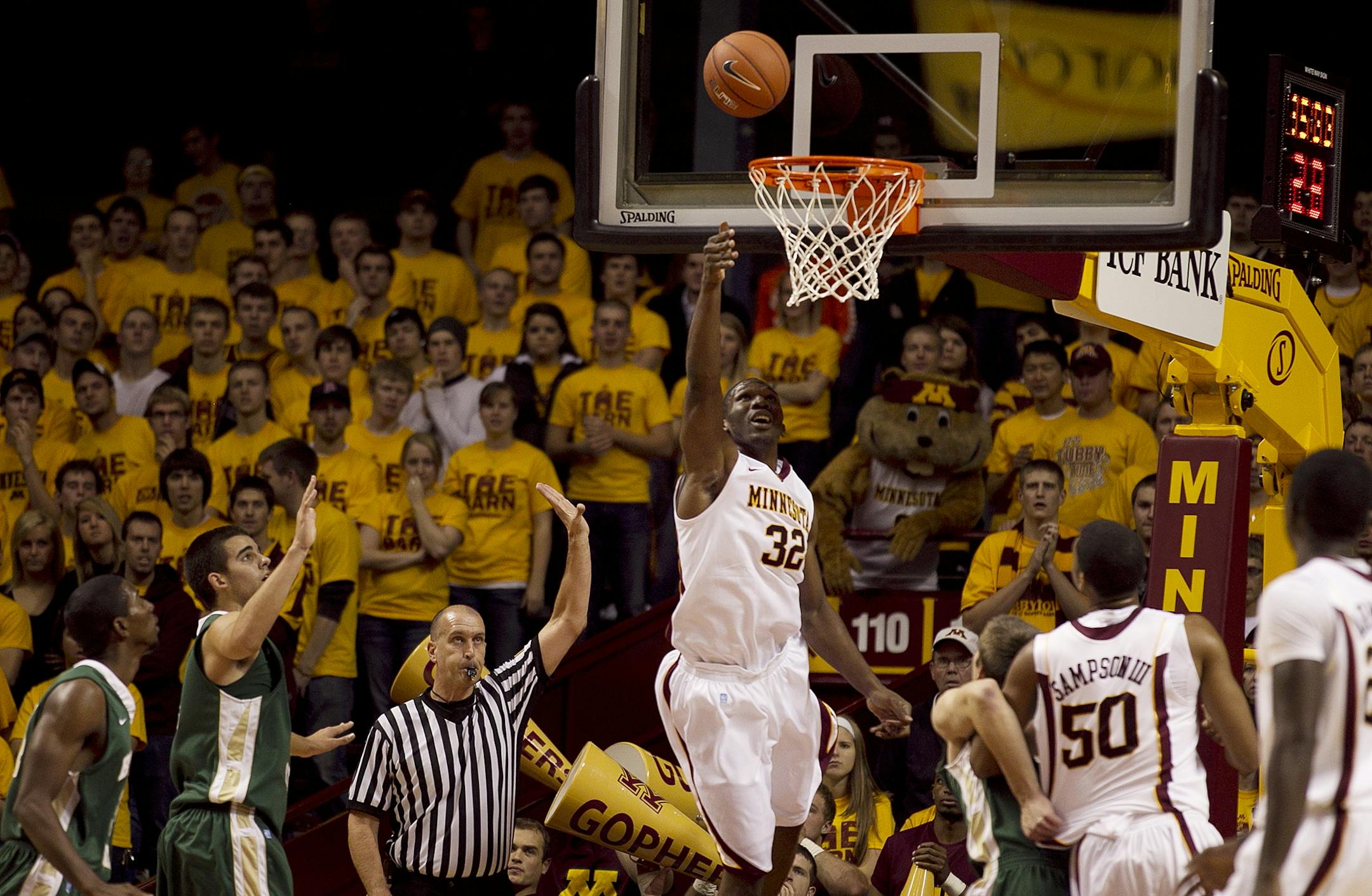 Minnesota's Trevor Mbakwe scored over Bemidji State 's defenders in the first half of basketball action, during Tuesday November 1, 2011 exhibition game between Minnesota and. Bemidji State.