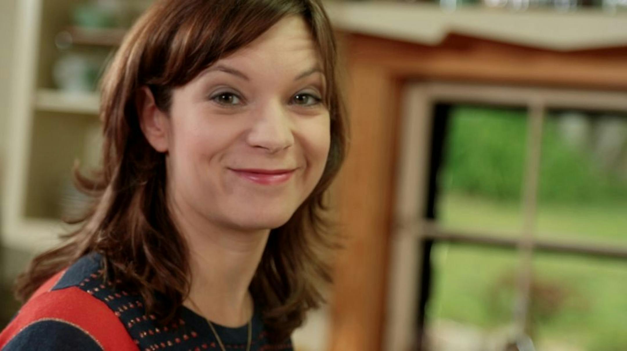 Credit: Food Network Host Amy Thielen smiling, as seen on Food Network's Heartland Table.