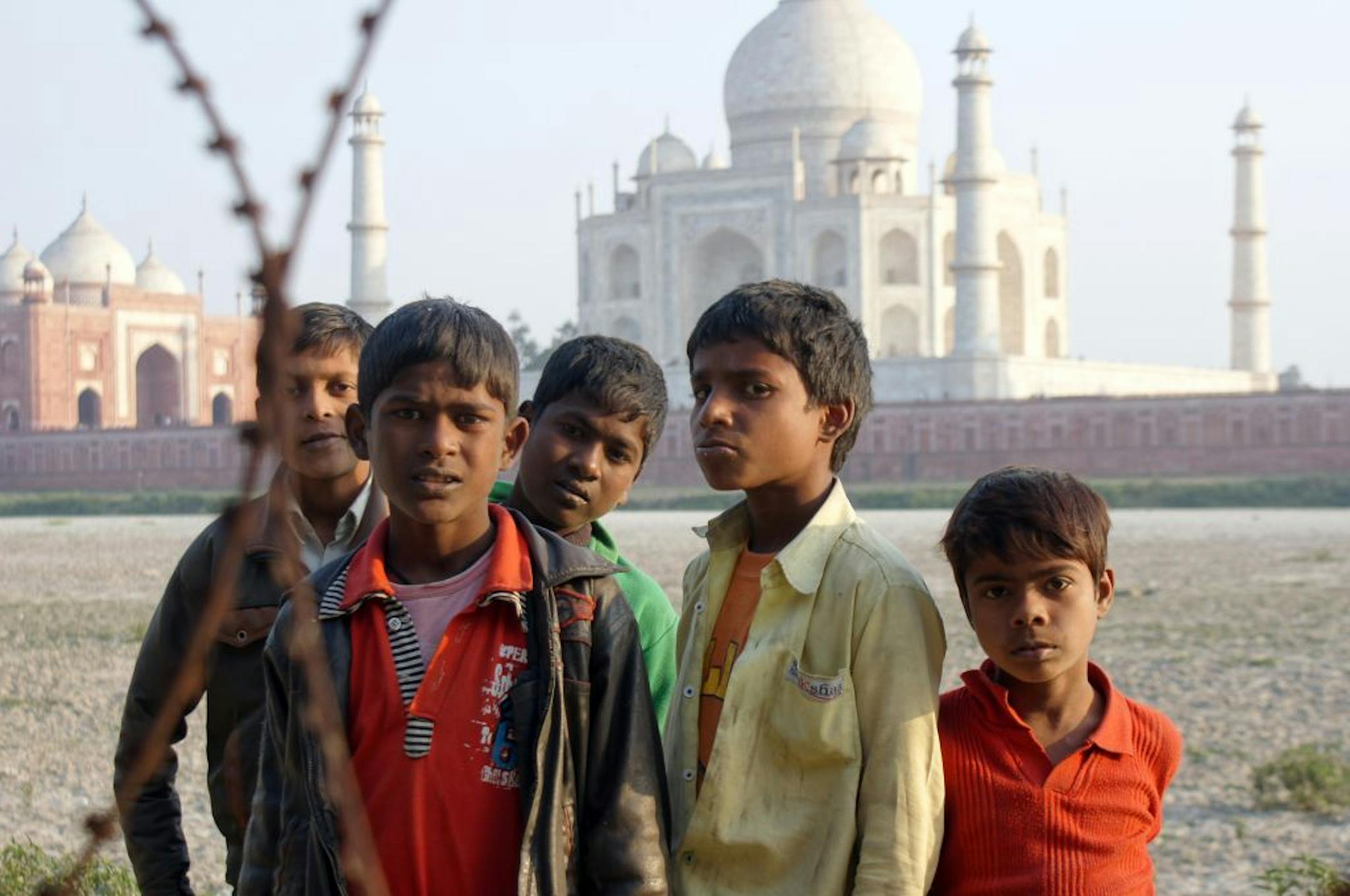 The photographer: Brad Benson of Minnetonka. The scene: Benson wanted to capture the Taj Mahal at sunset from the north bank of the Yamuna River in Agra and came across a group of children herding goats. They asked Benson to take their photo. "They were all quite pleased to see their photos displayed on the back of my camera. These children were herding their family's goats , but the area was guarded by the army/security staff, hence the barb wire," he explained in an e-mail.