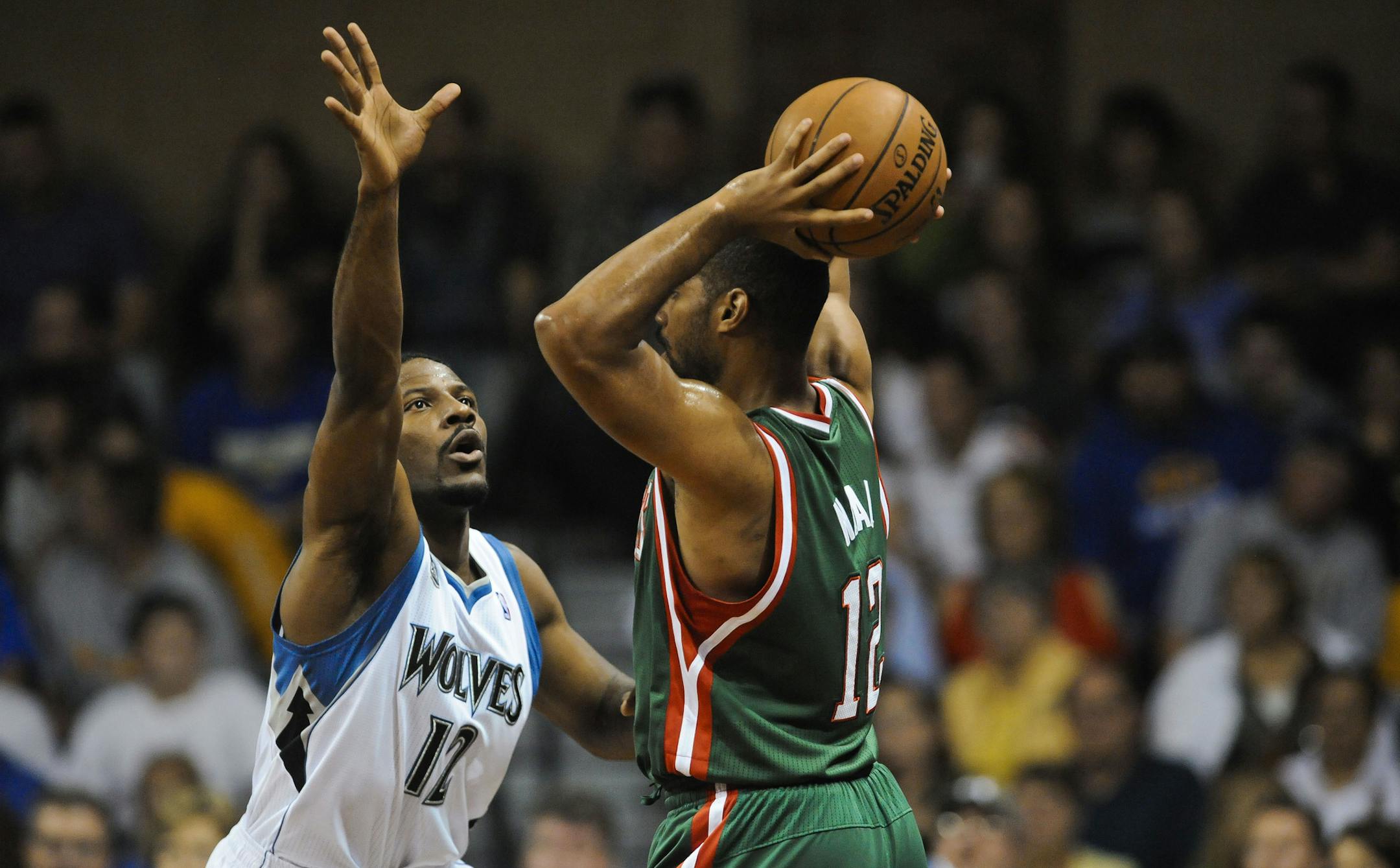 Minnesota Timberwolves shooting guard Othyus Jeffers (12) guards Milwaukee Bucks point guard Gary Neal (12) during their Thursday Oct 10, 2013 NBA game in Sioux Falls, SD.(AP Photo/Dave Weaver)