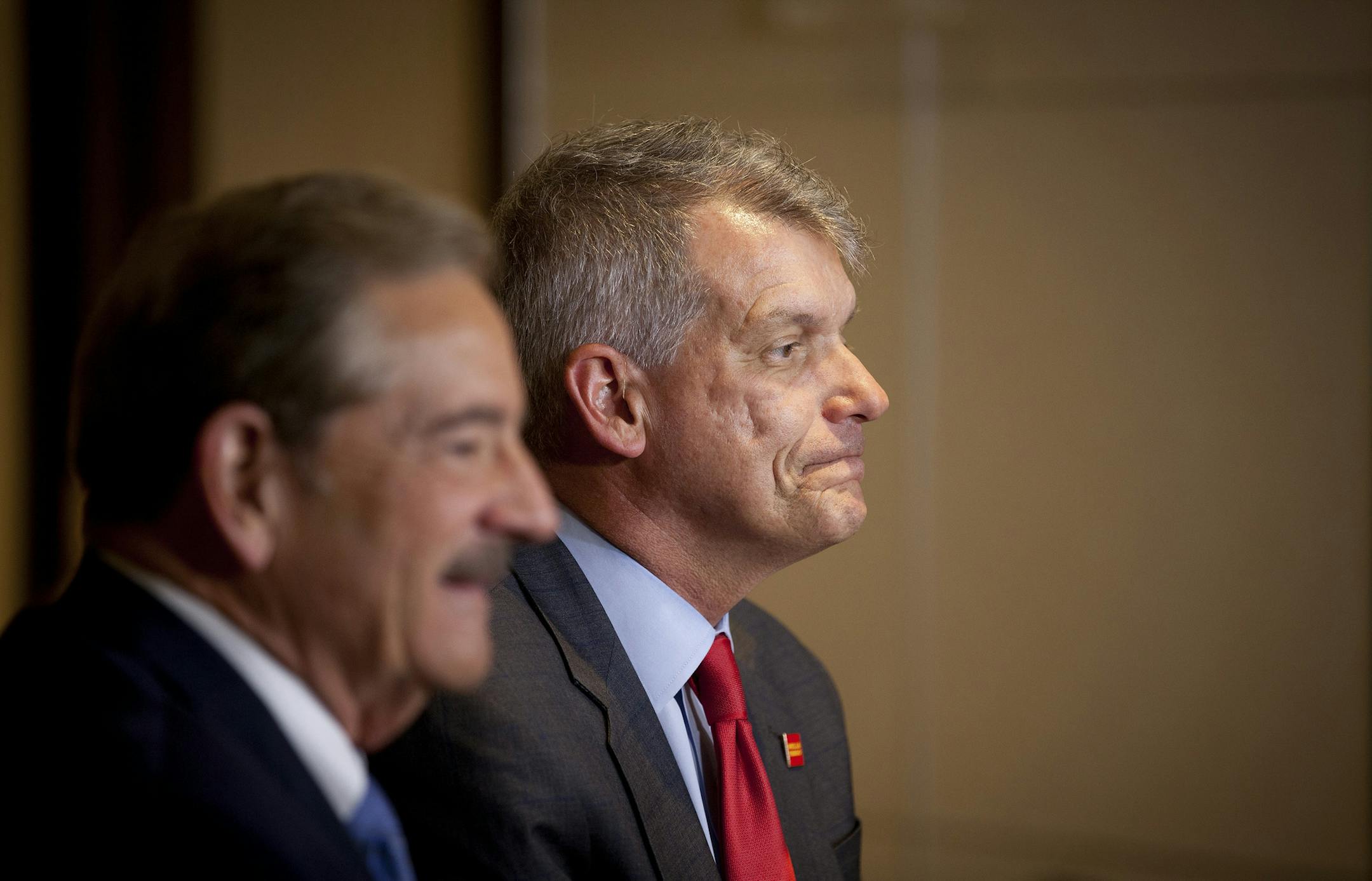 Tim Sloan, right, chief executive of Wells Fargo, and Stephen Sanger, chairman of the bank's board, left, talk with reporters after a shareholders meeting in Ponte Vedra Beach, Fla., April 25, 2017. Despite the turmoil that has engulfed Wells Fargo in the past year, shareholders voted Tuesday to re-elect all of the bankís 15 directors. But some of the board members edged in just barely. (Charlotte Kesl/The New York Times)