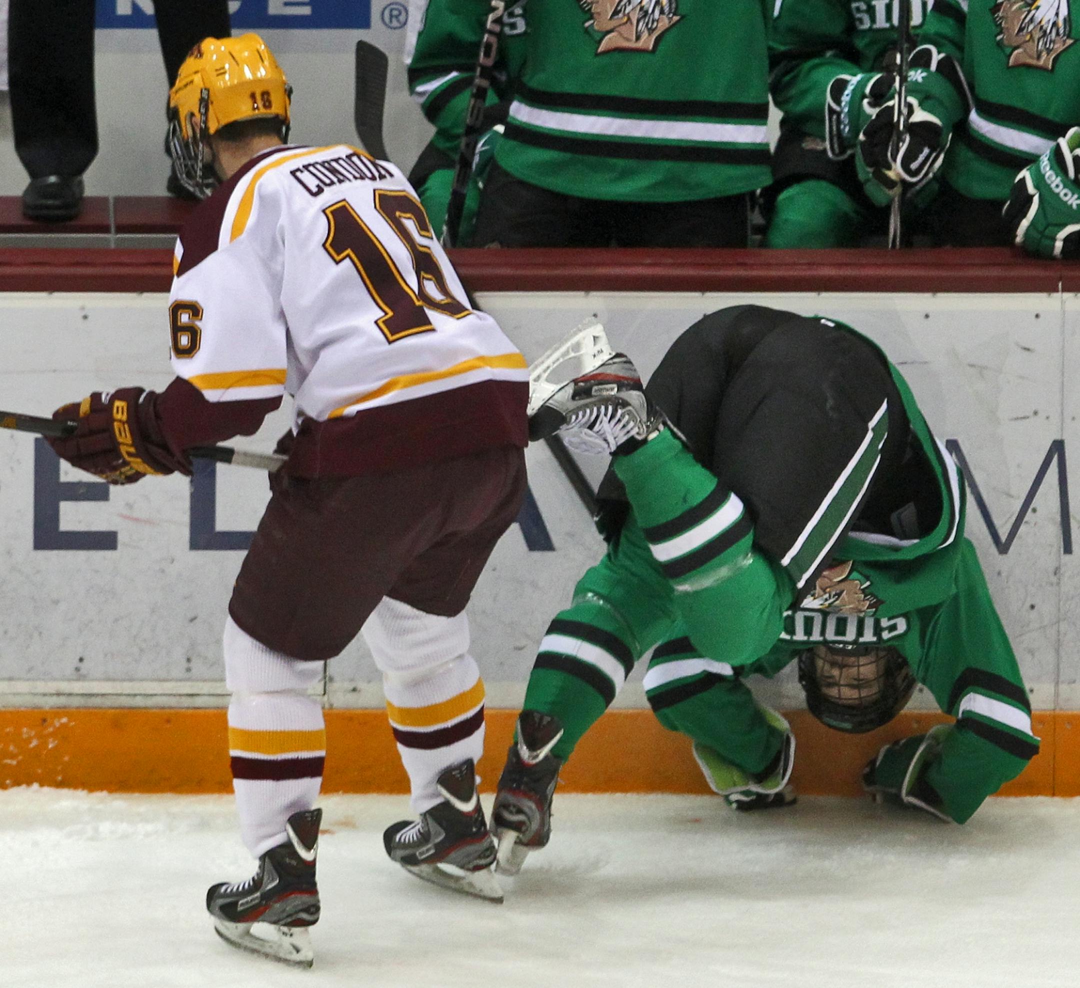Minnesota Gophers vs. North Dakota hockey. It was another physical game between the Gophers and Sioux as Gophers Nate Condon (16) sent Sioux Derek Rodwell into the boards in first period action.