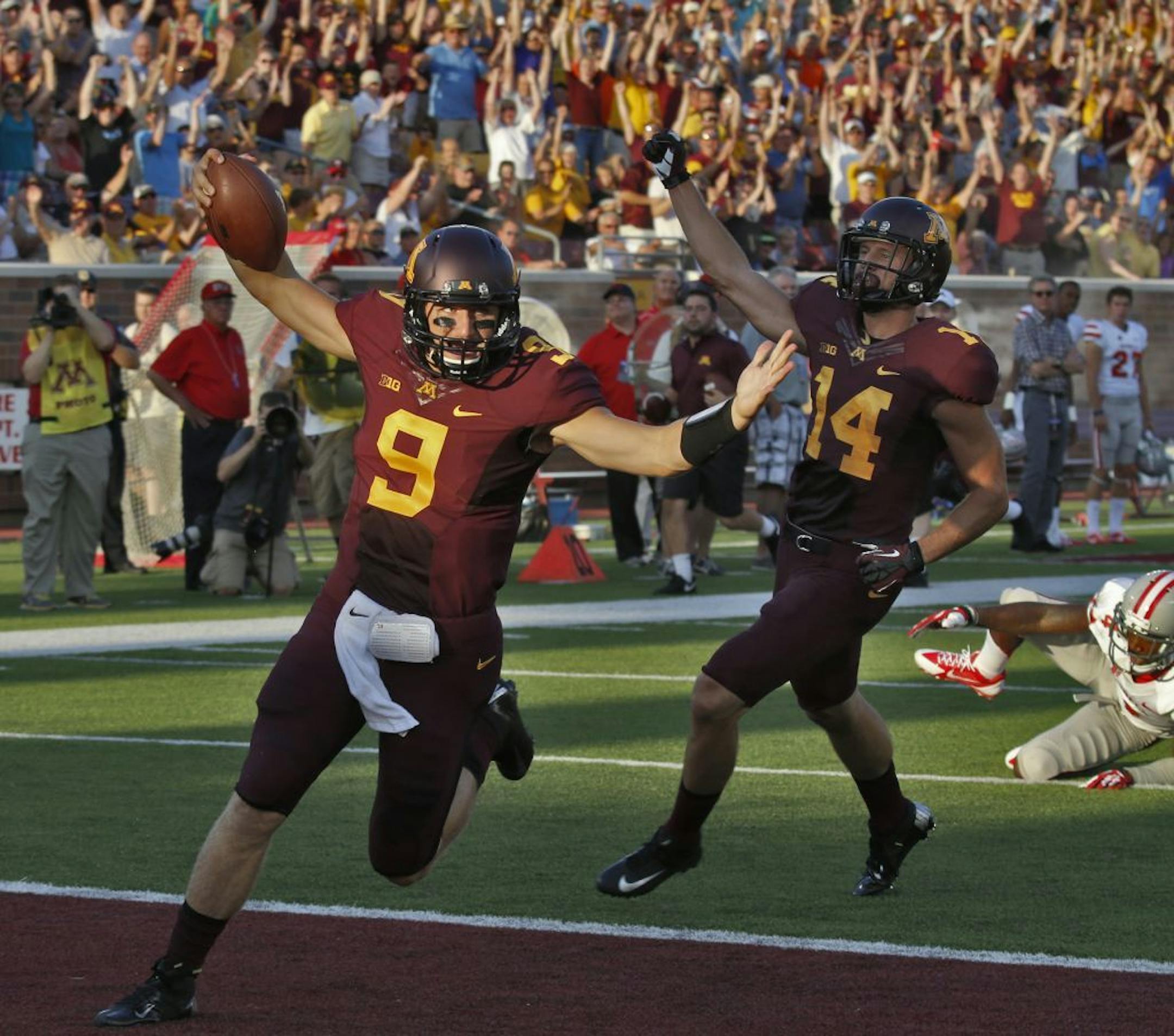 Gophers quarterback Philip Nelson (9) celebrated his 48-yard touchdown run, the longest of his career, in first half action.