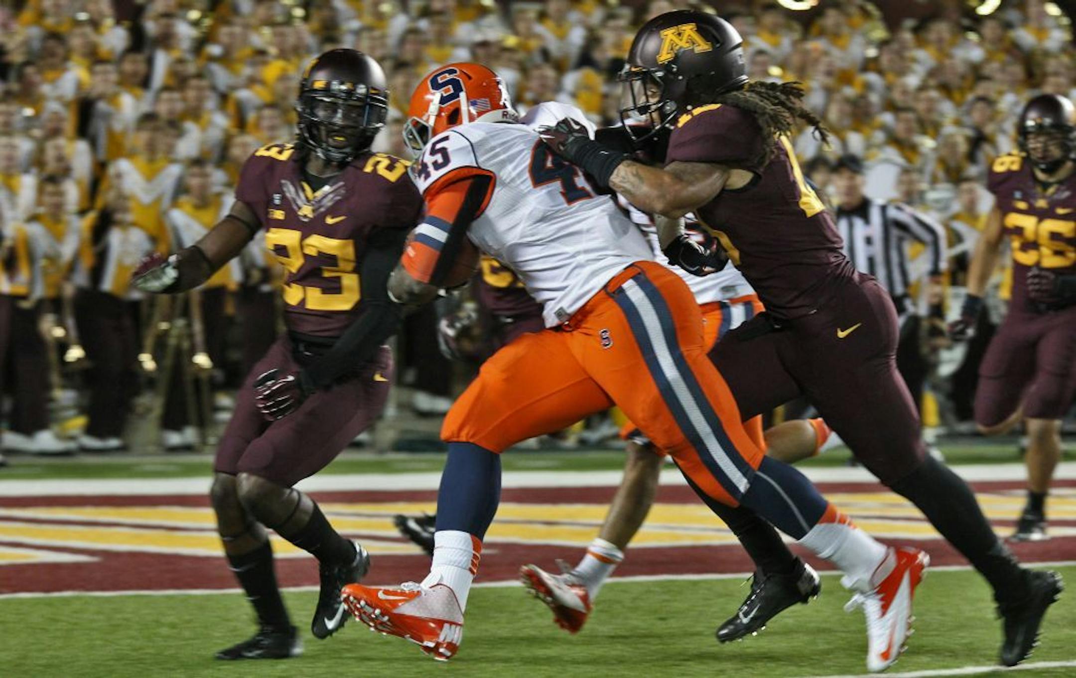 Minnesota's defense stymies Syracuse running back Jerome Smith for no gain.