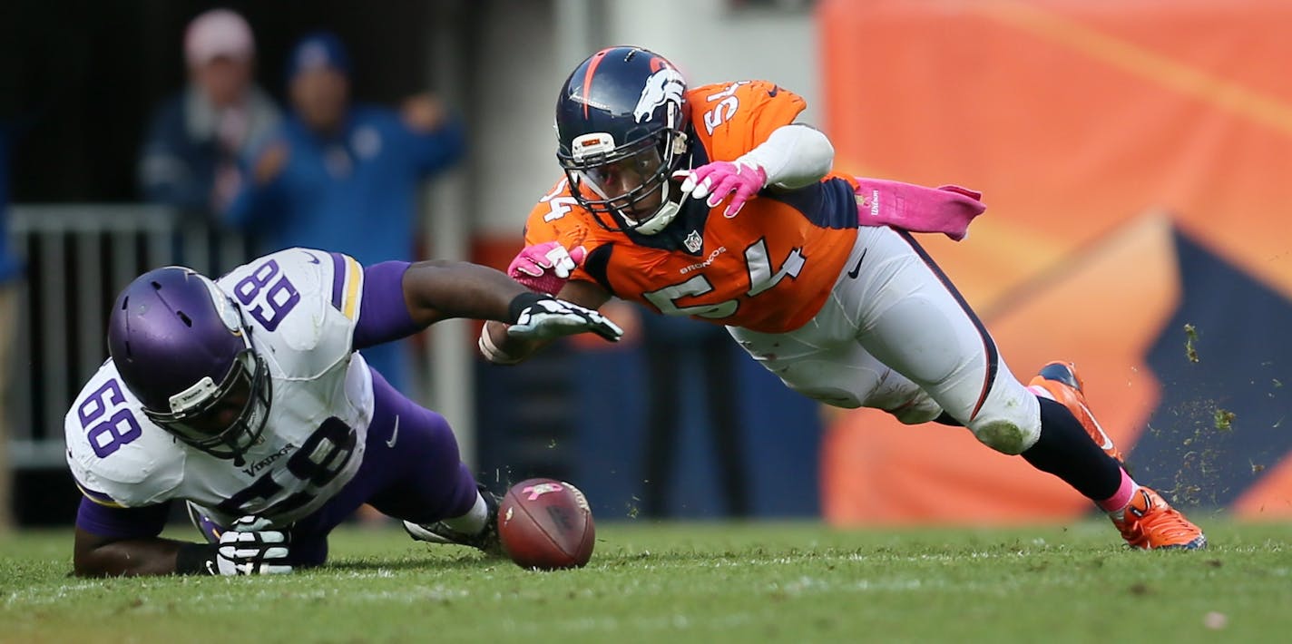 Vikings, T.J. Clemmings and Denver's Brandon Marshall scramble for a loose ball after Teddy Bridgewater was strip sacked on the final play of the game. The ball was recovered by Denver's Von Miller.