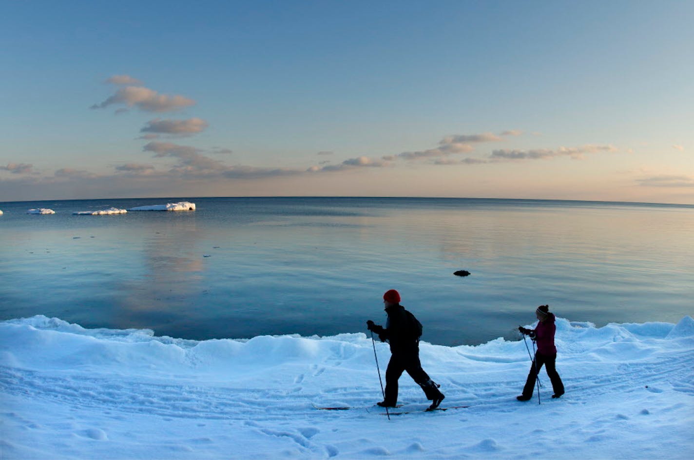 To stay fit during cold weather, embrace winter sports such as cross-country skiing. Lake Superior provided a nice backdrop for this couple.