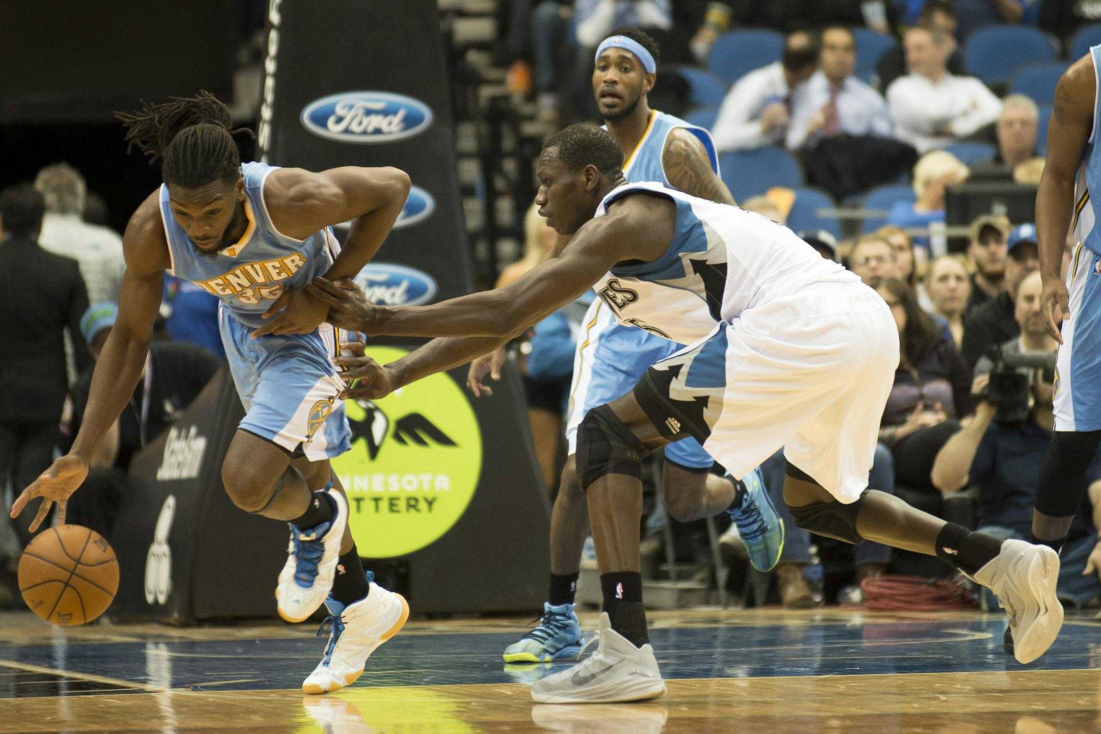 Minnesota Timberwolves center Gorgui Dieng (5) fouls Denver Nuggets forward Kenneth Faried (35) after Faried stole the ball from Dieng in the third quarter. ] (Aaron Lavinsky | StarTribune) The Minnesota Timberwolves play the Denver Nuggets on Wednesday, March 4, 2015 at Target Center.
