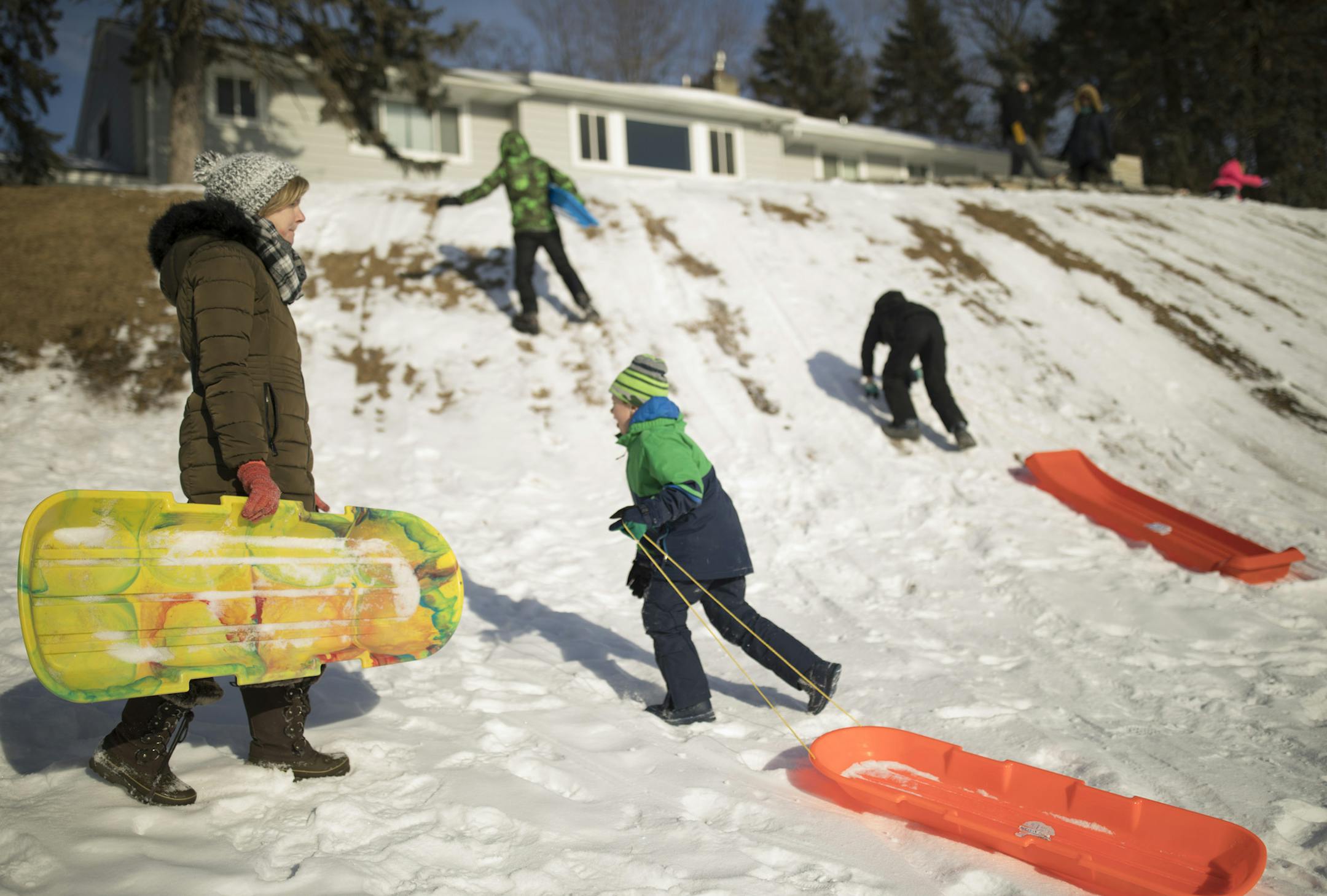 Amy Olson on the sledding hill with kids from the Lake Cornelia neighborhood during the sledding party earlier this month. ] JEFF WHEELER ï jeff.wheeler@startribune.com Lake Cornelia, one of the newest official neighborhoods in Edina, held its first ever sledding party for neighbors at Arneson Acres Park Sunday afternoon, February 11, 2018.